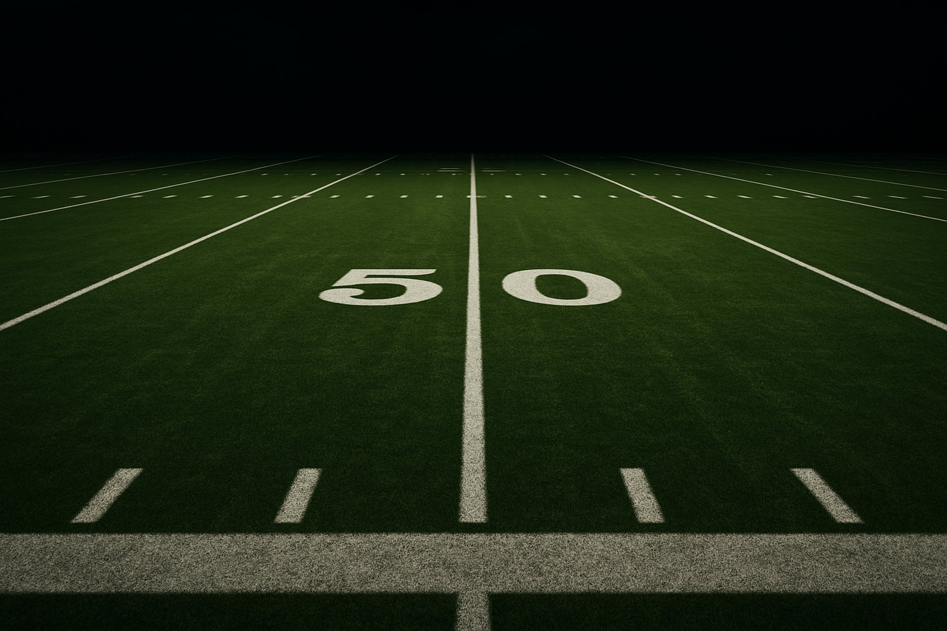 an empty soccer field at night with the lights on