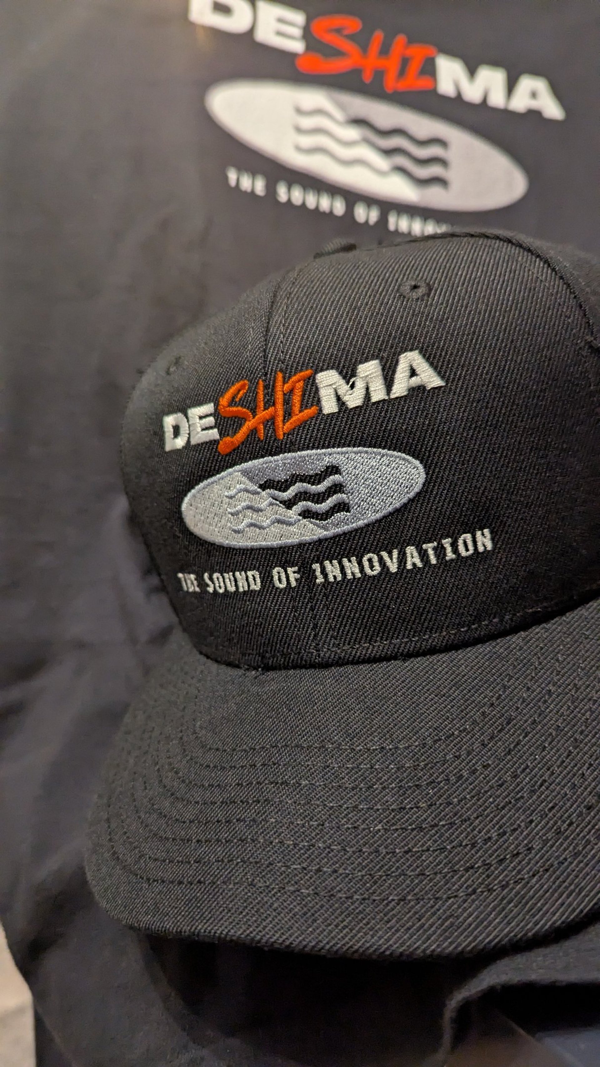 grayscale photo of woman standing beside microphone