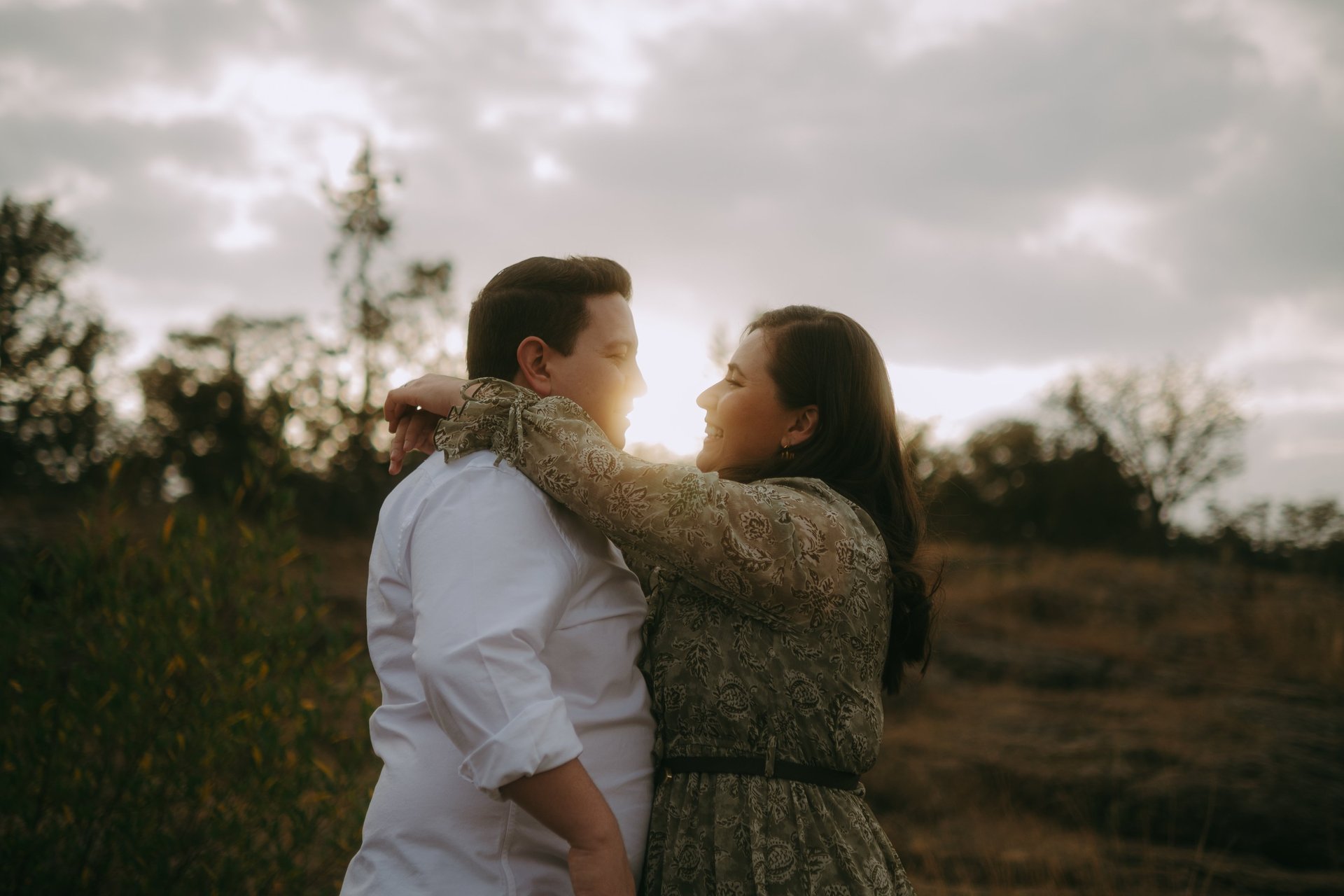 two person holding hands on white flower