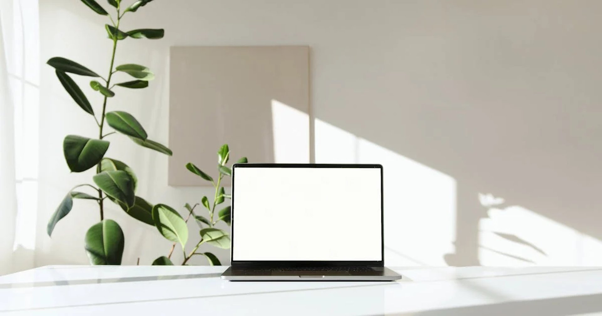 MacBook Pro, white ceramic mug,and black smartphone on table