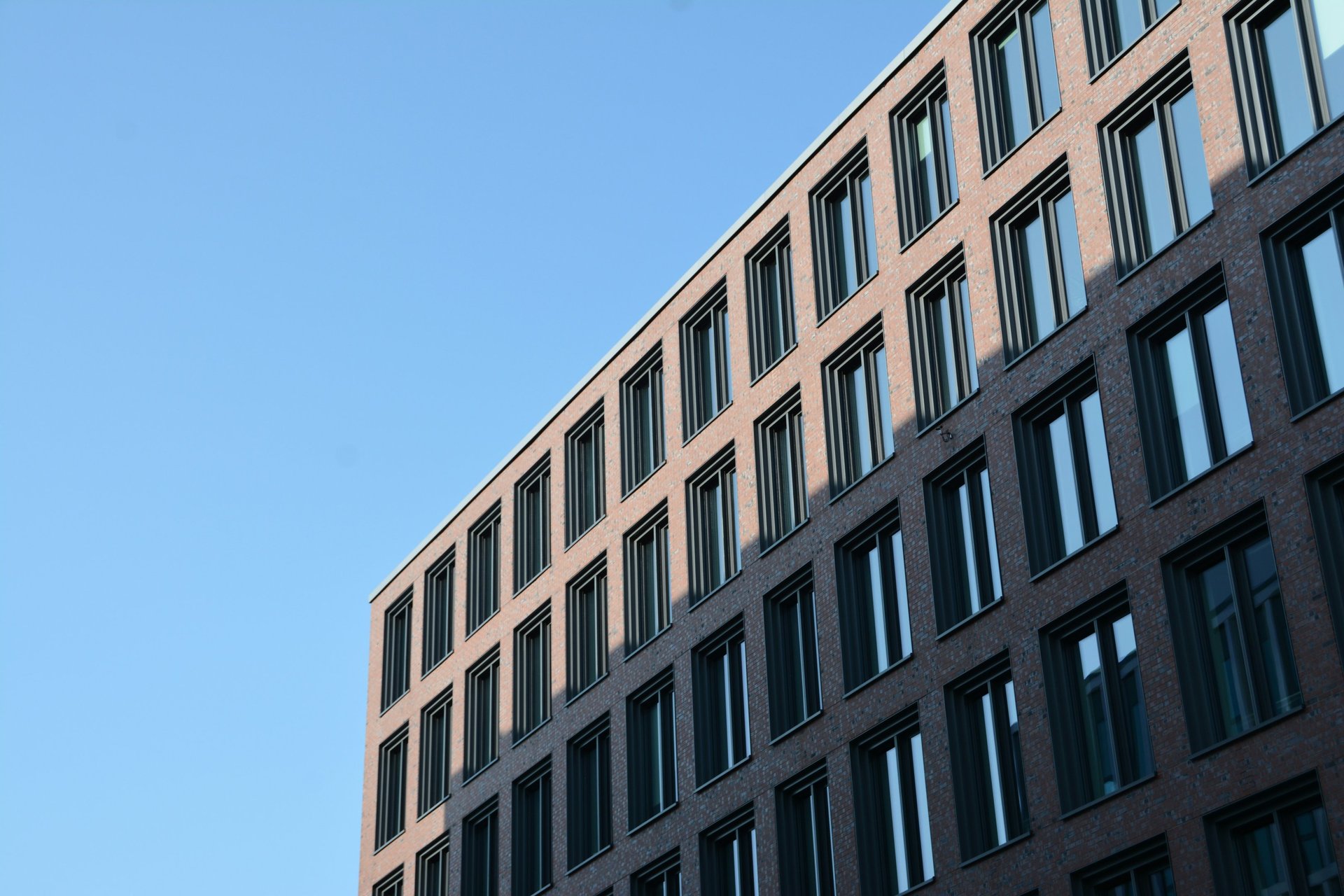 a tall building with plants growing on the side of it