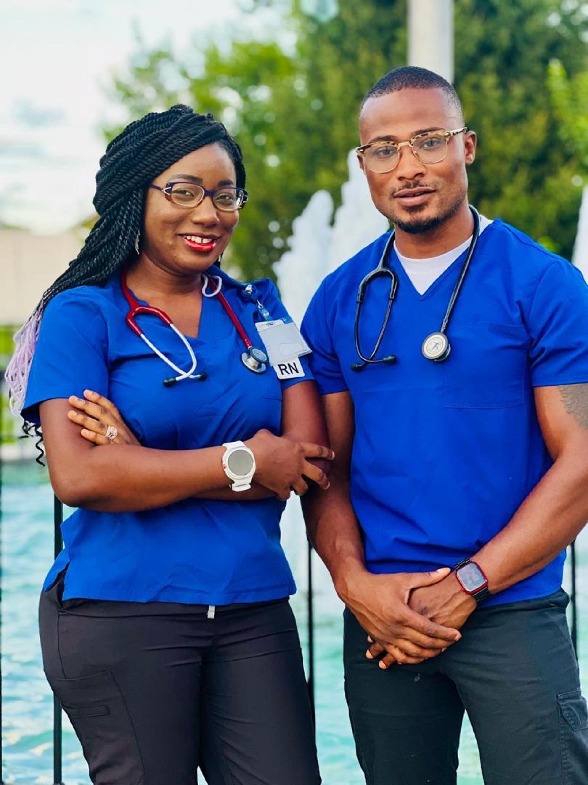 a woman in a blue scrub suit and a man in a blue scrub suit