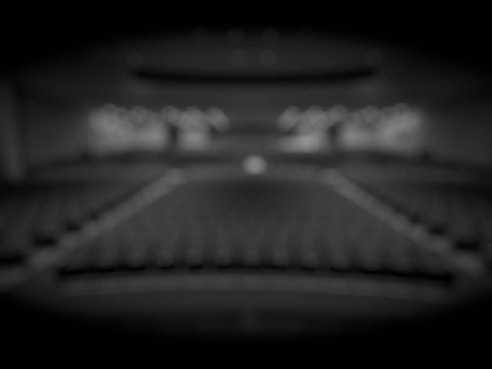 people standing on stage with lights turned on during nighttime