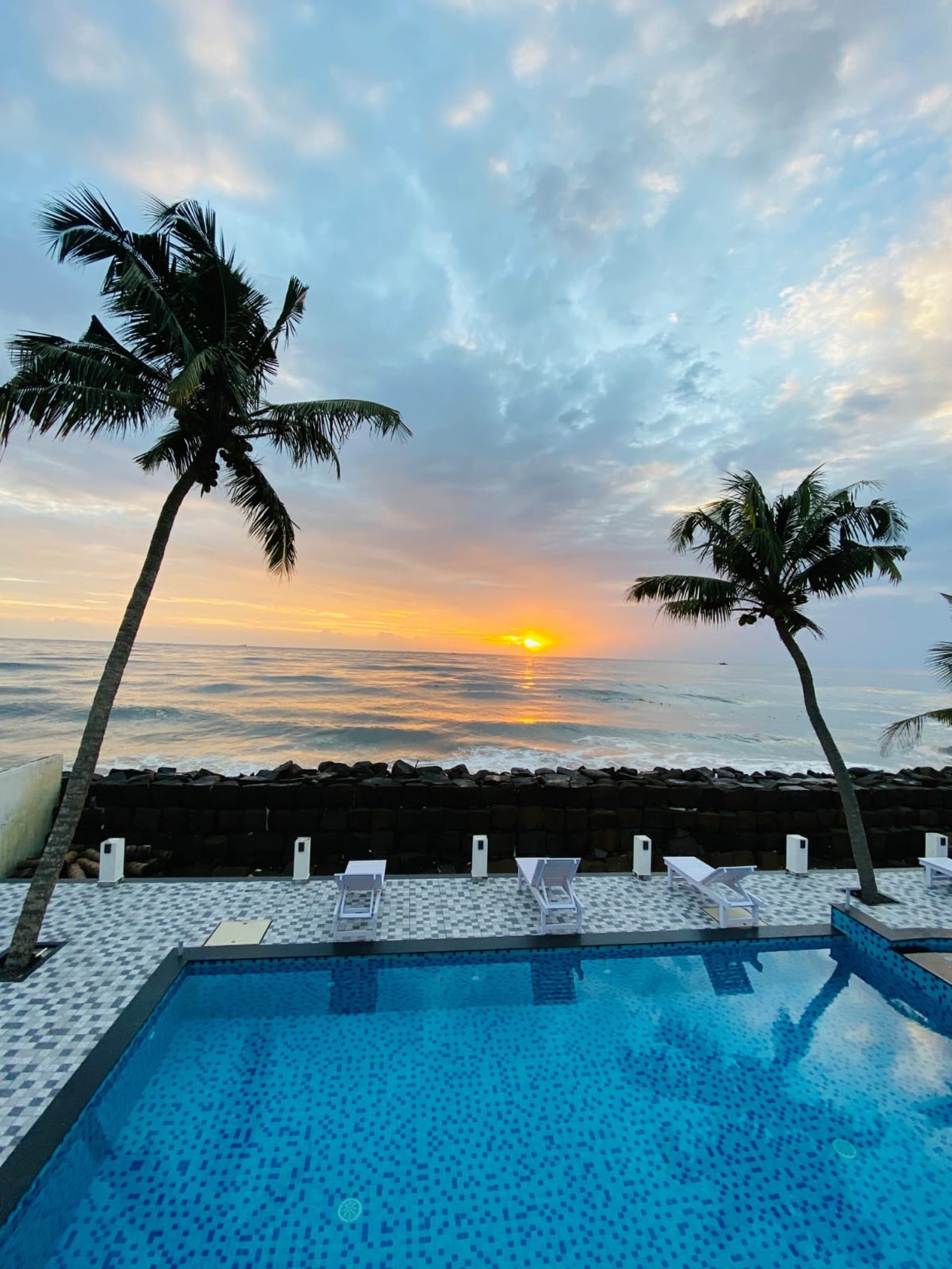 a sandy beach with waves crashing on it