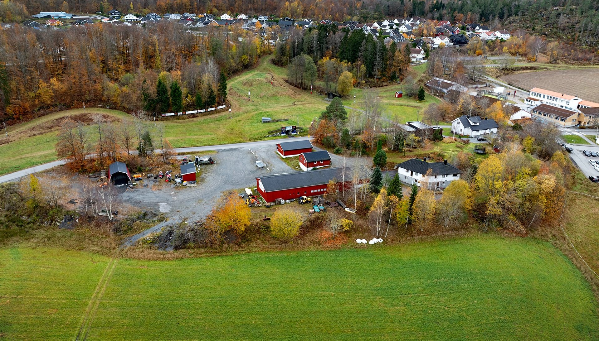 a house on a hill with a tree in the foreground
