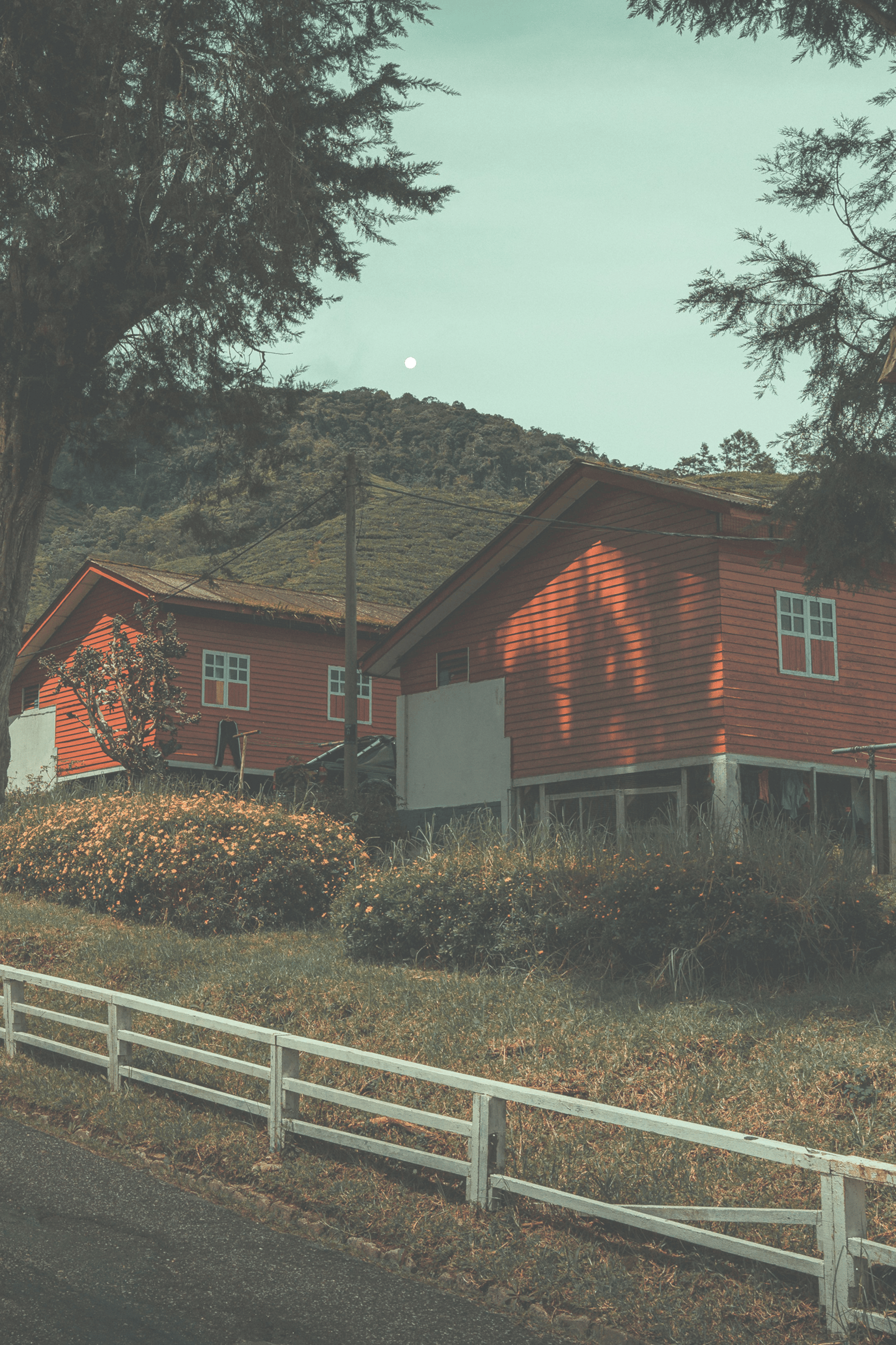 a red house sitting on the side of a road