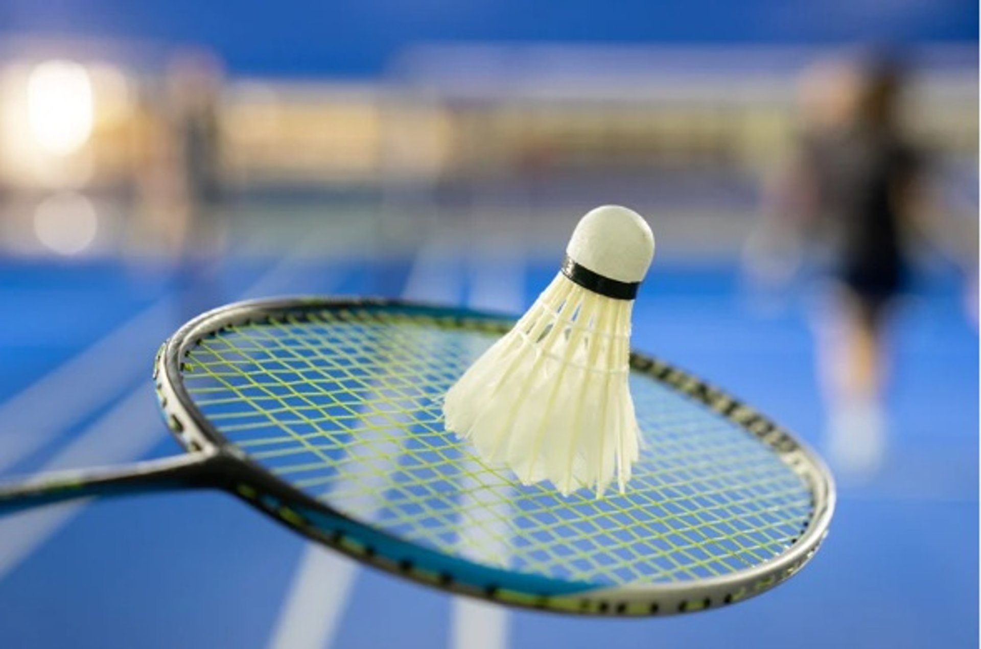 A man jumping in the air with a tennis racket