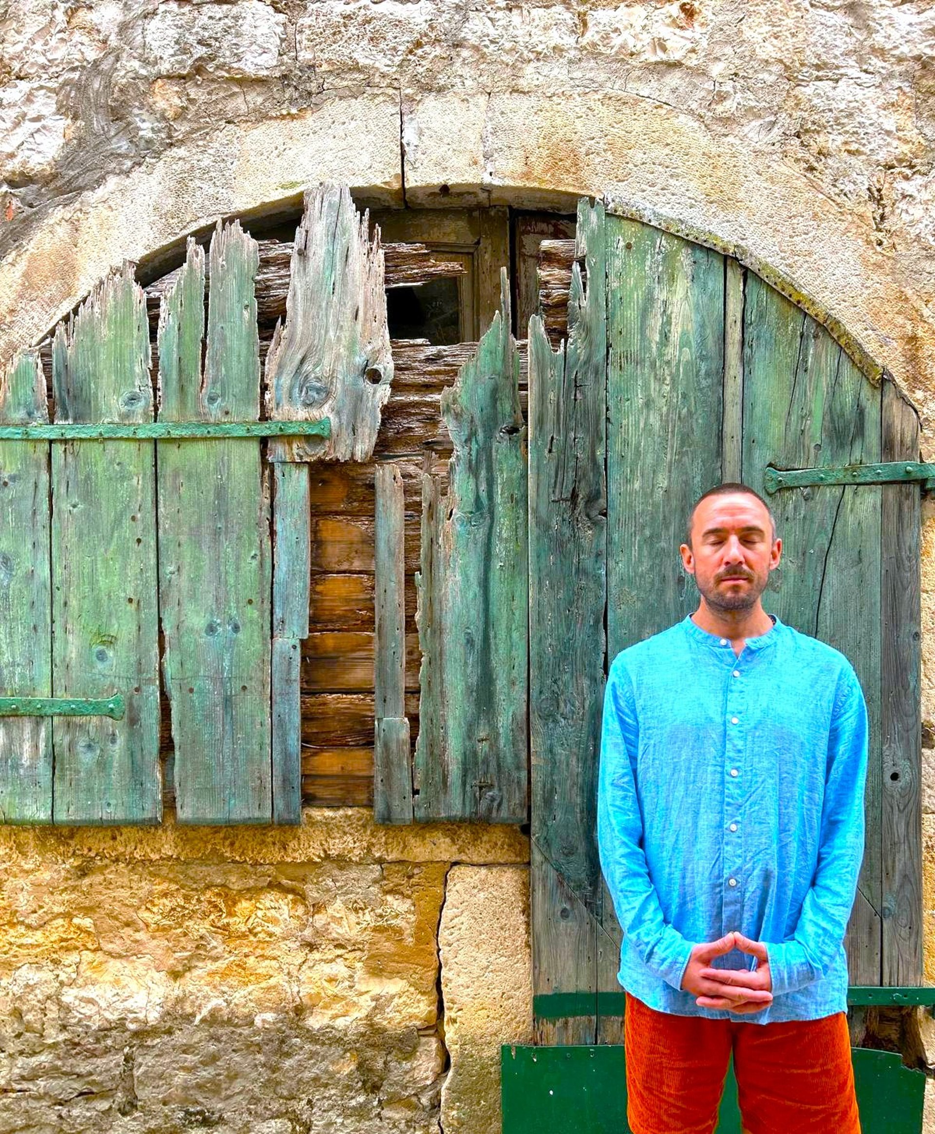 a black lamp sitting on top of a white wall
