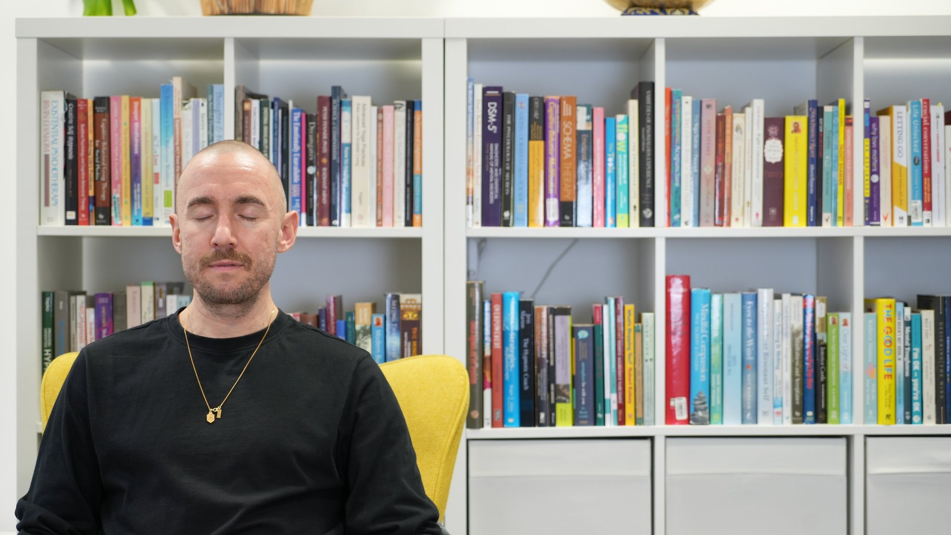 a black lamp sitting on top of a white wall