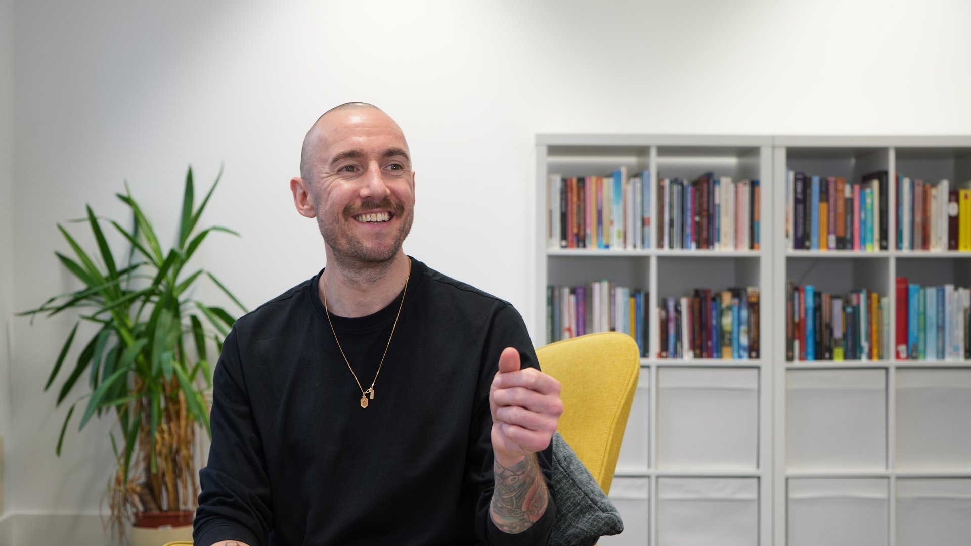 a black lamp sitting on top of a white wall
