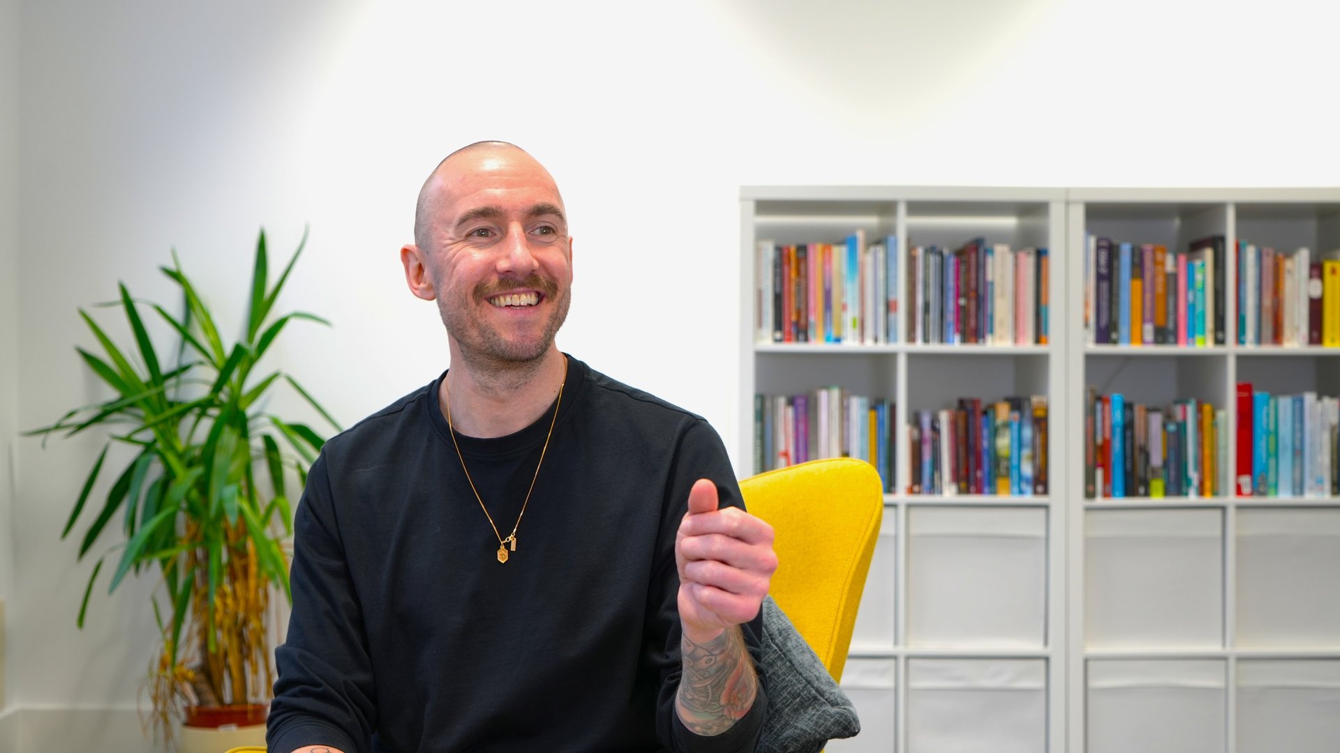 a black lamp sitting on top of a white wall