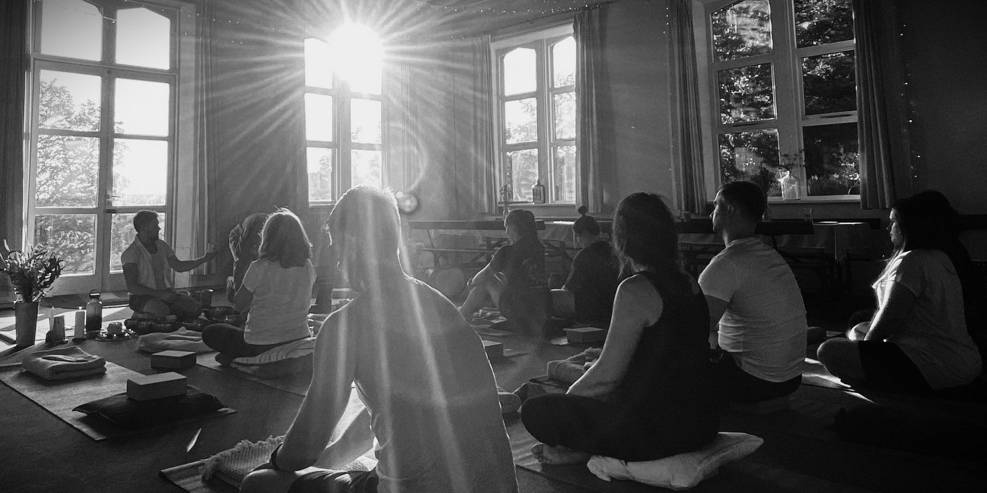 woman in black tank top and black pants bending her body on floor