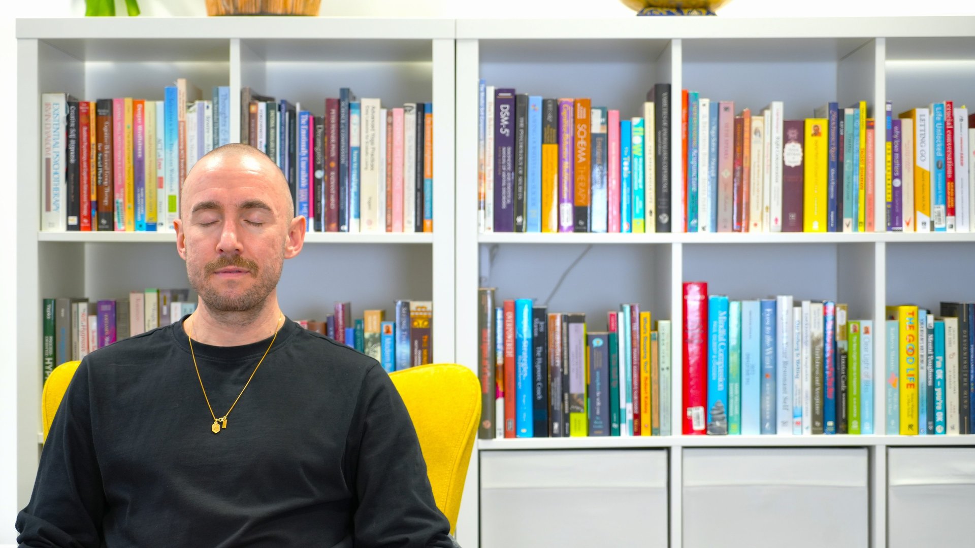 a black lamp sitting on top of a white wall