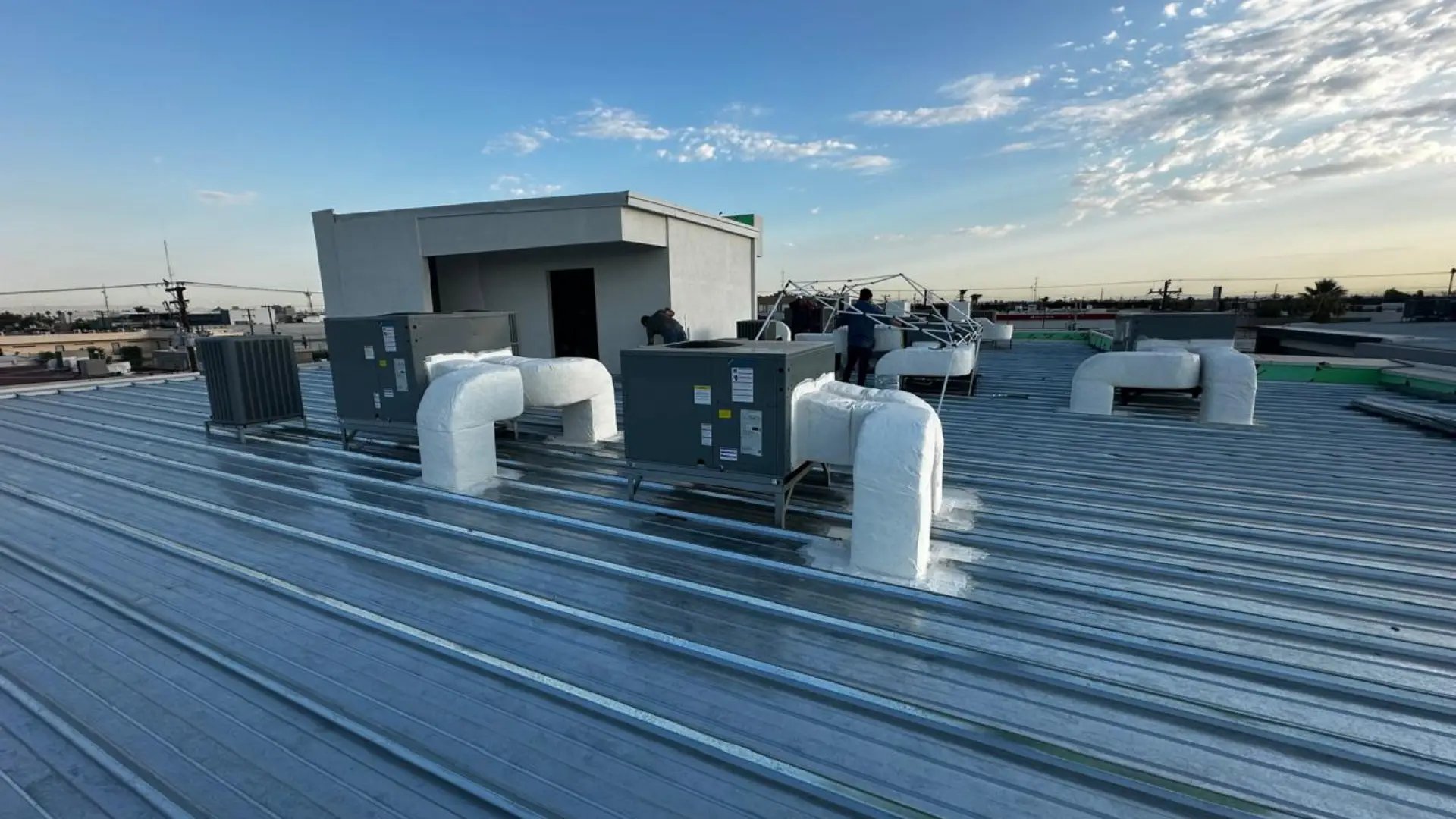 an abstract photo of a curved building with a blue sky in the background