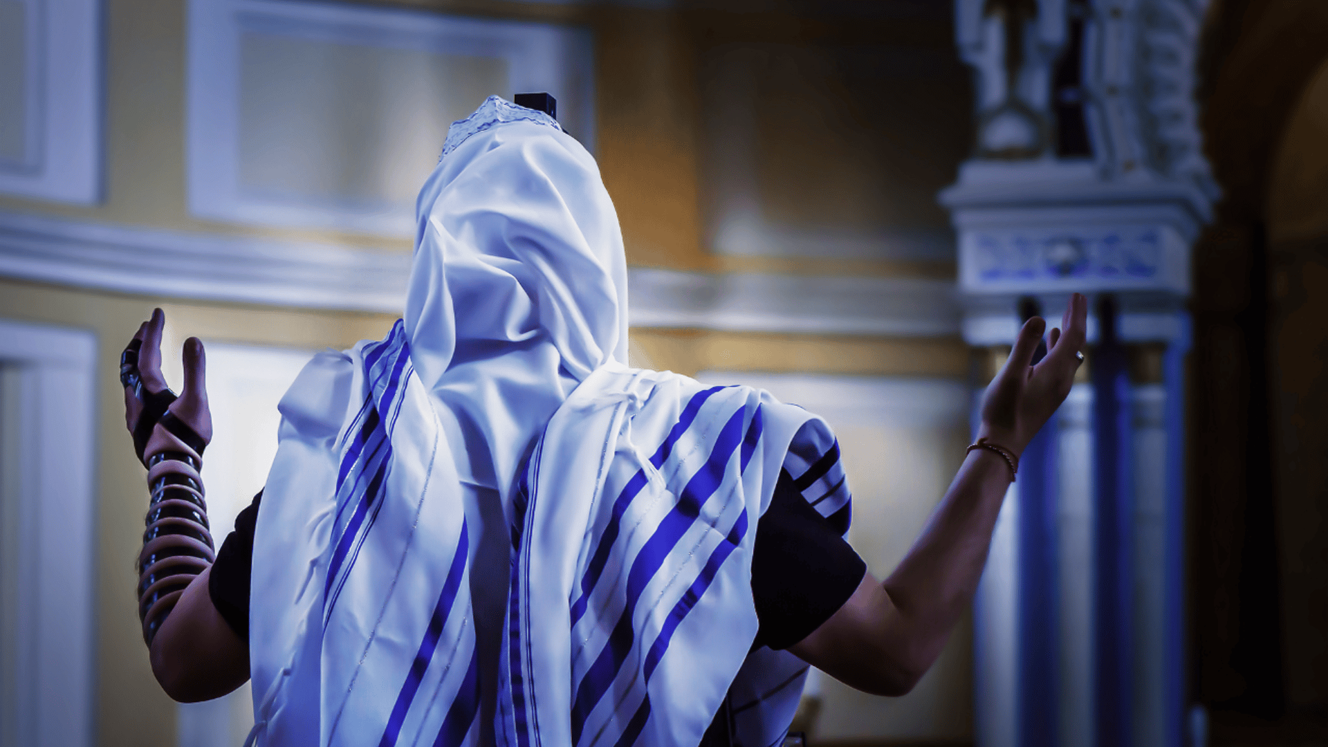 man sitting on gray rock while staring at white clouds