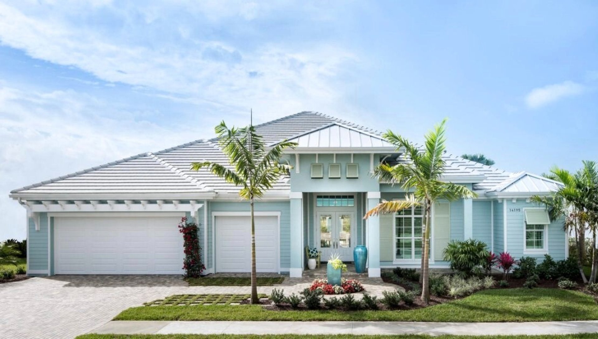 a blue house with a white picket fence
