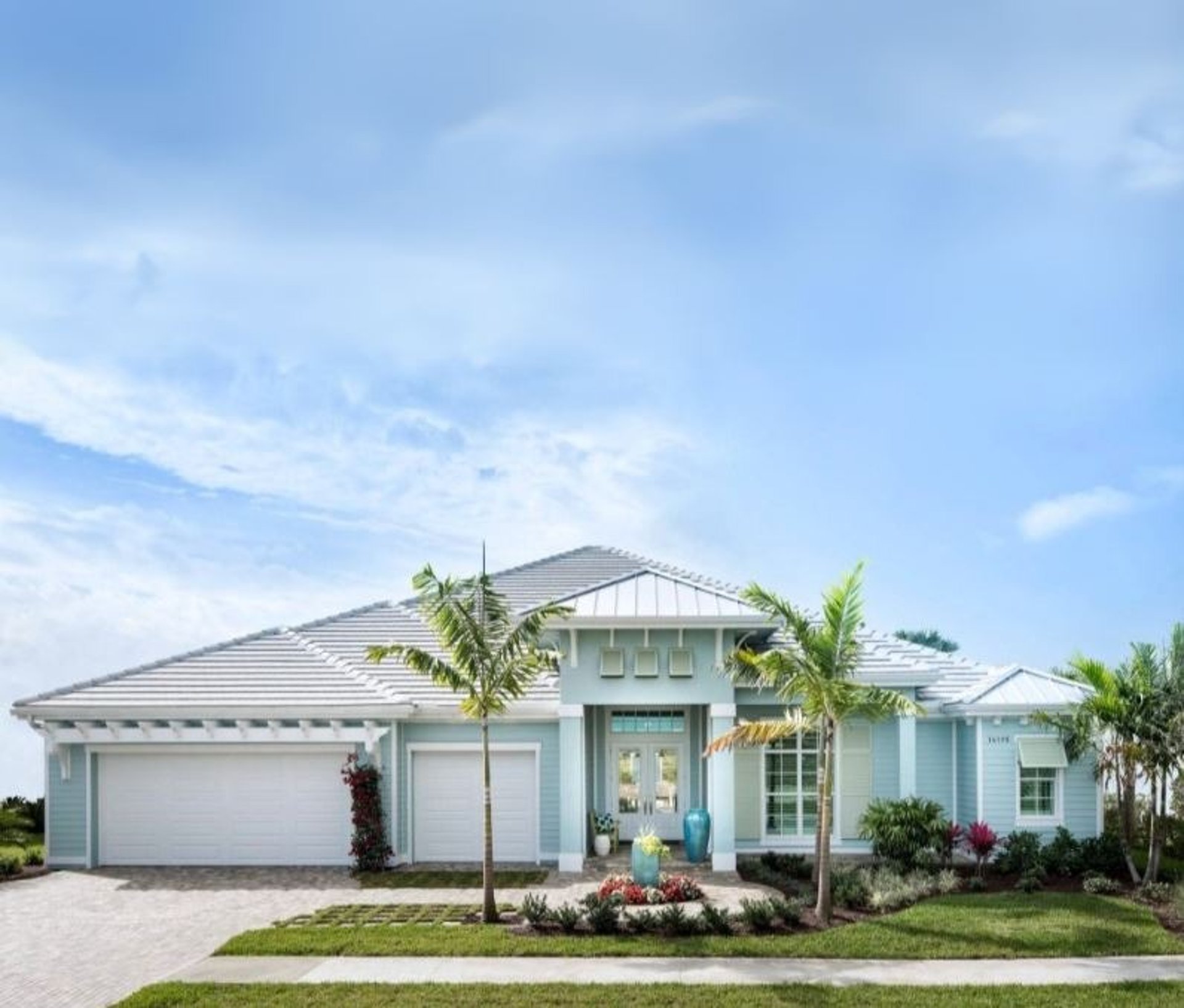 a blue house with a white picket fence