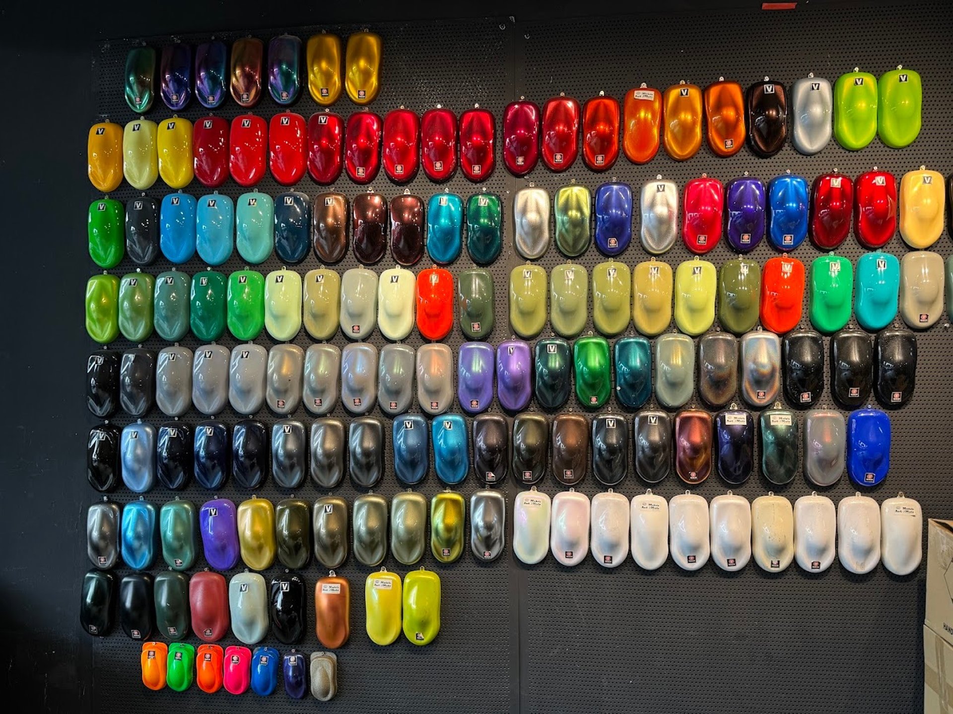 A car parked in front of a colorful wall