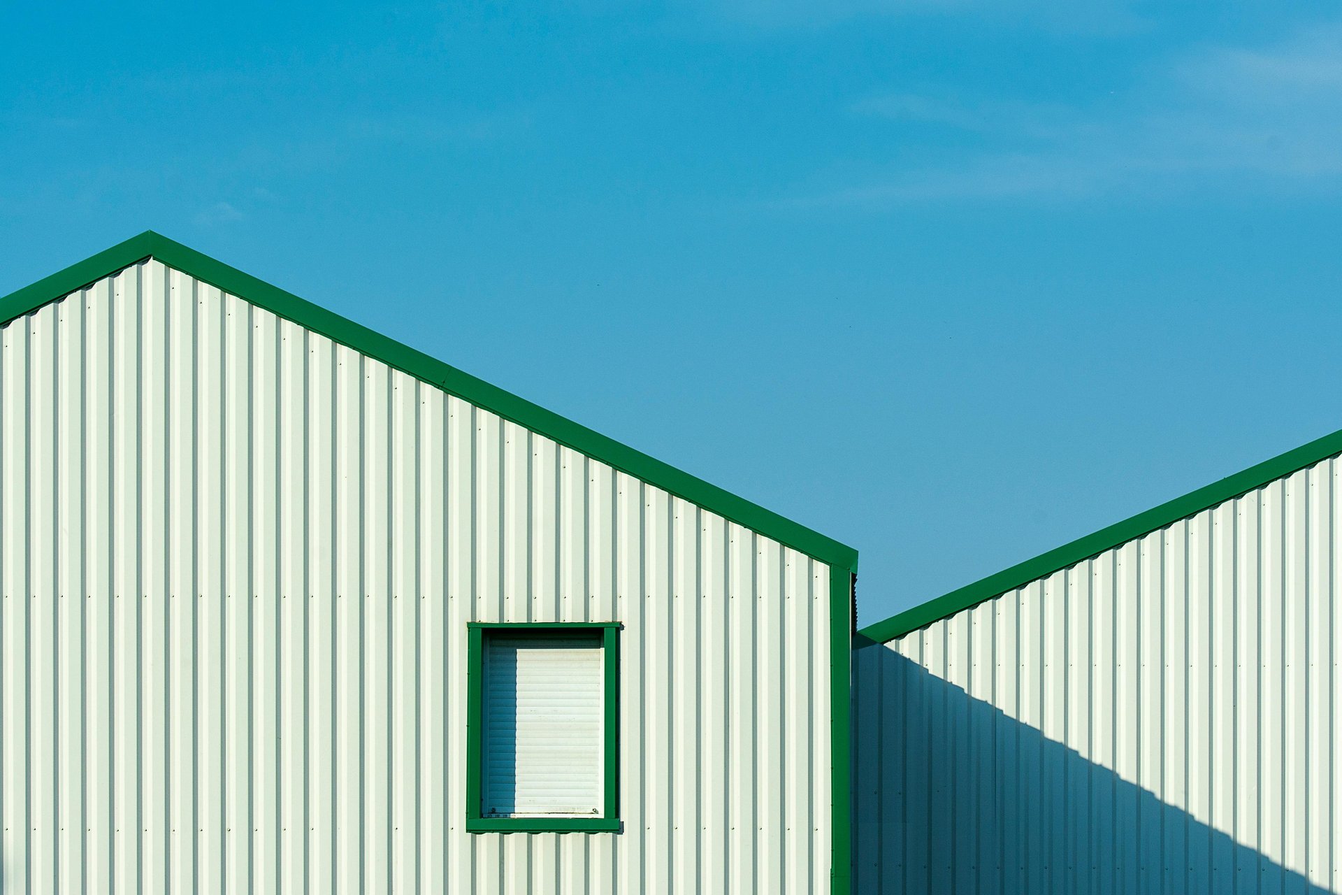 an abstract photo of a curved building with a blue sky in the background