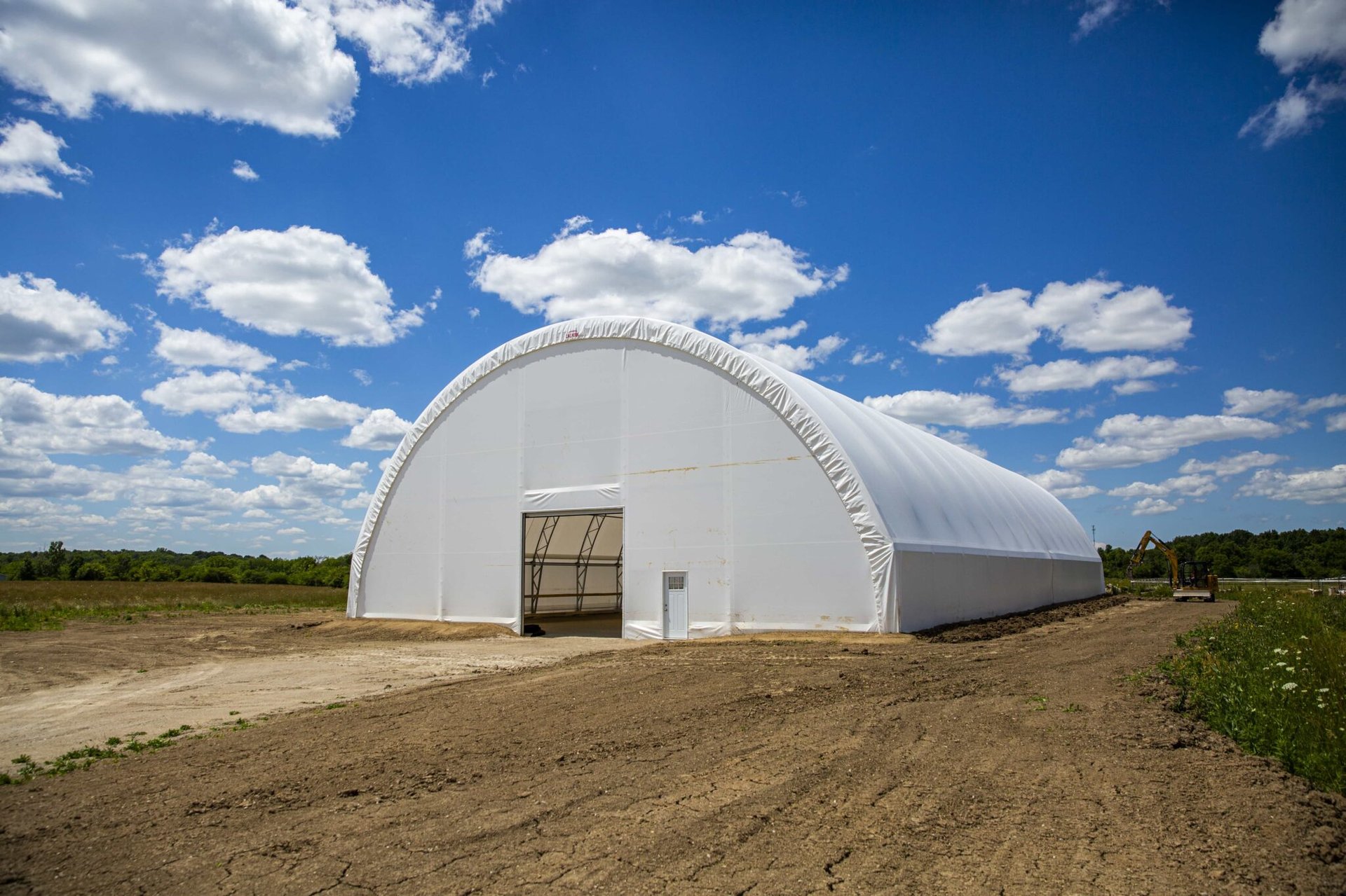 an abstract photo of a curved building with a blue sky in the background