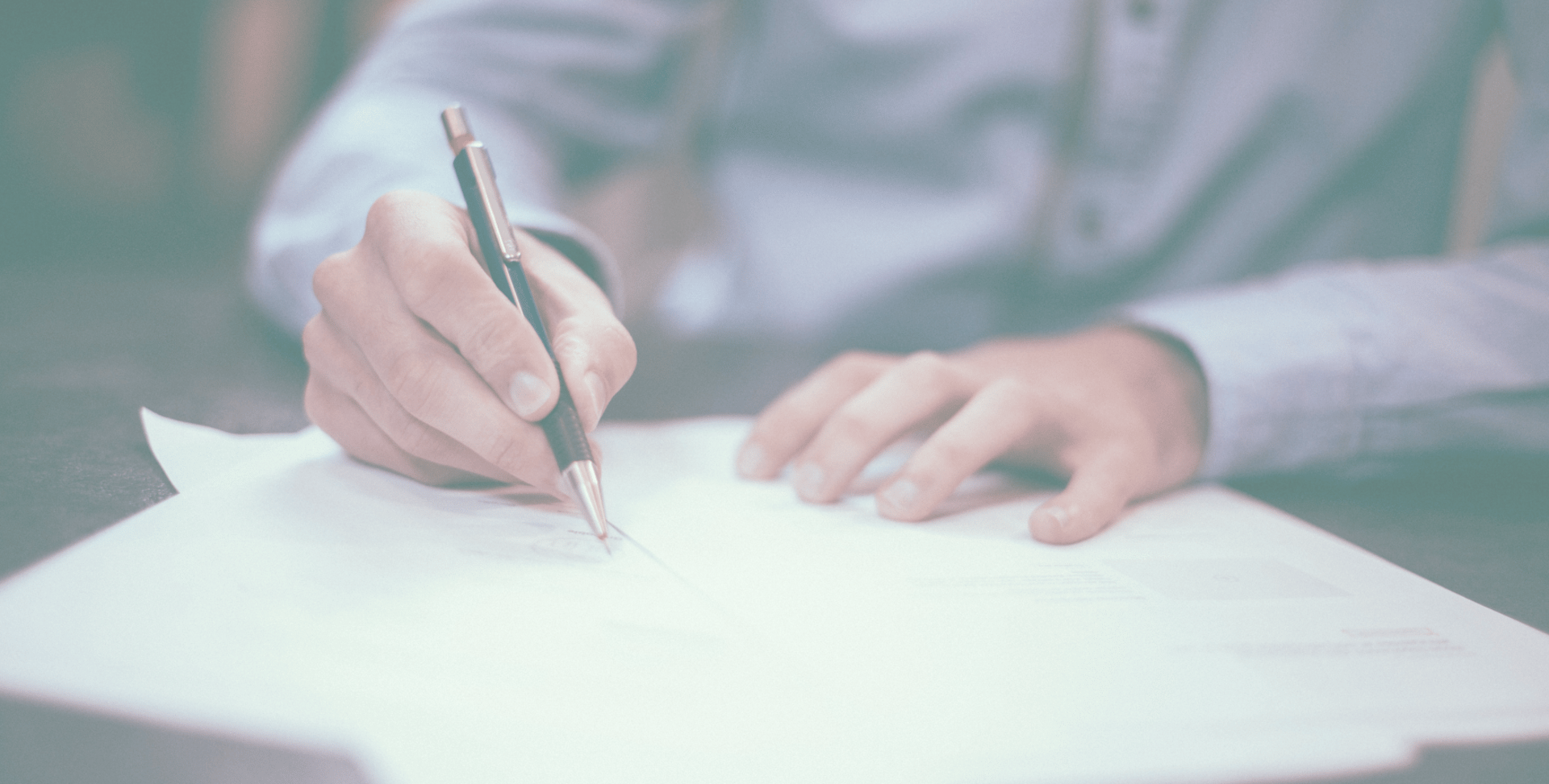 a person is writing on a piece of paper