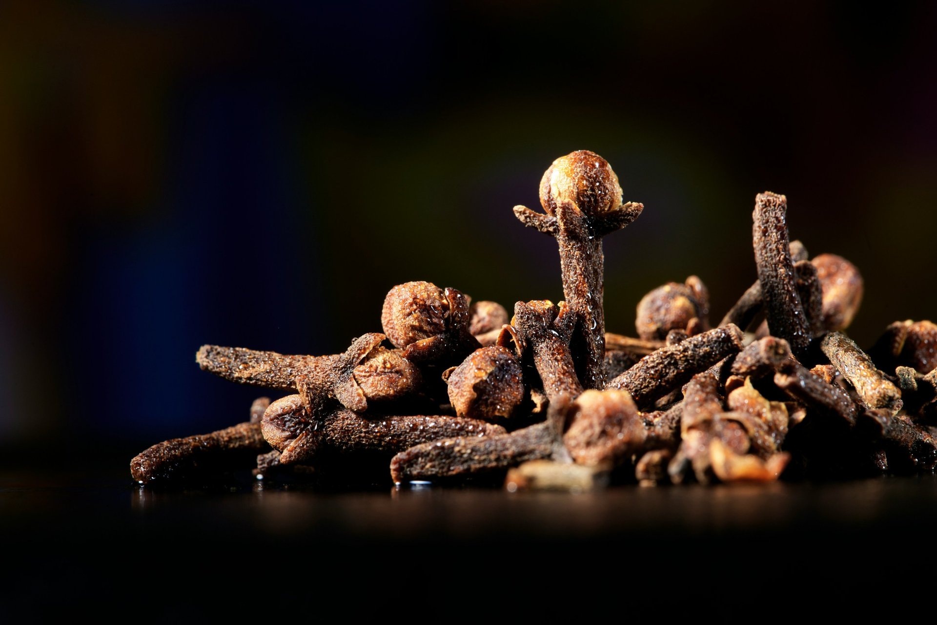 spices and herbs in wooden bowls on a table
