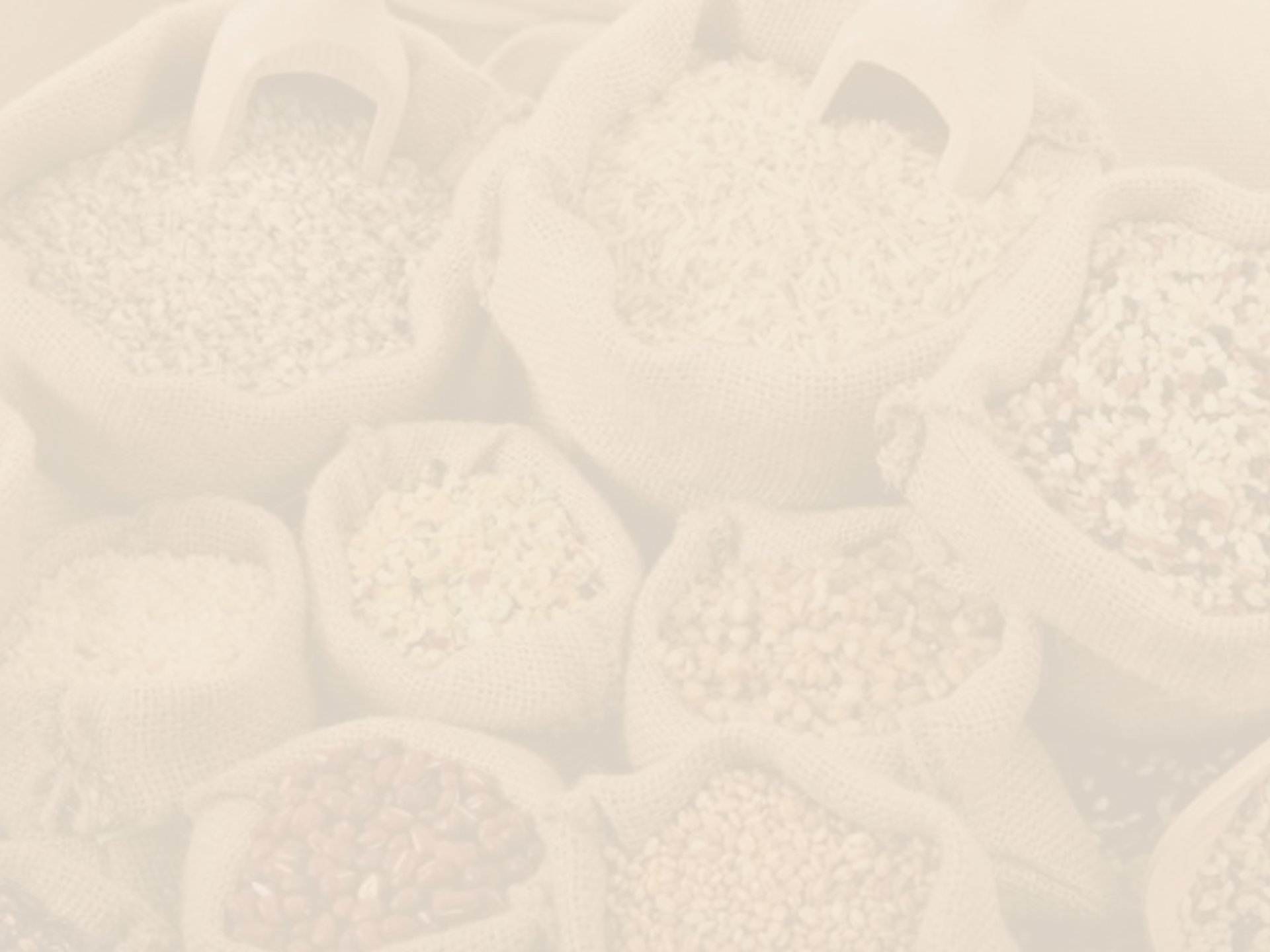 a basket filled with corn next to a pile of apples