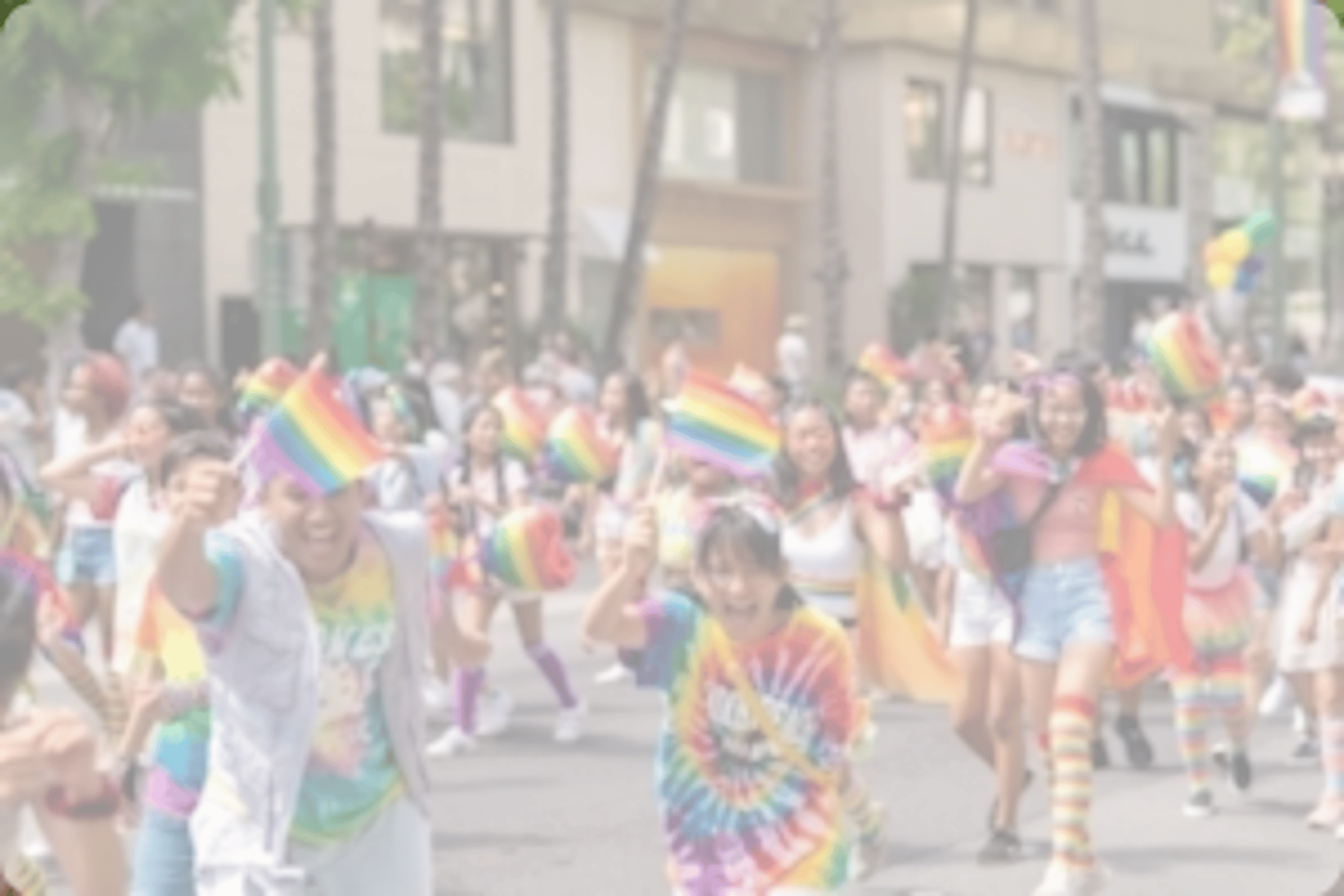 people walking in the street waving flags