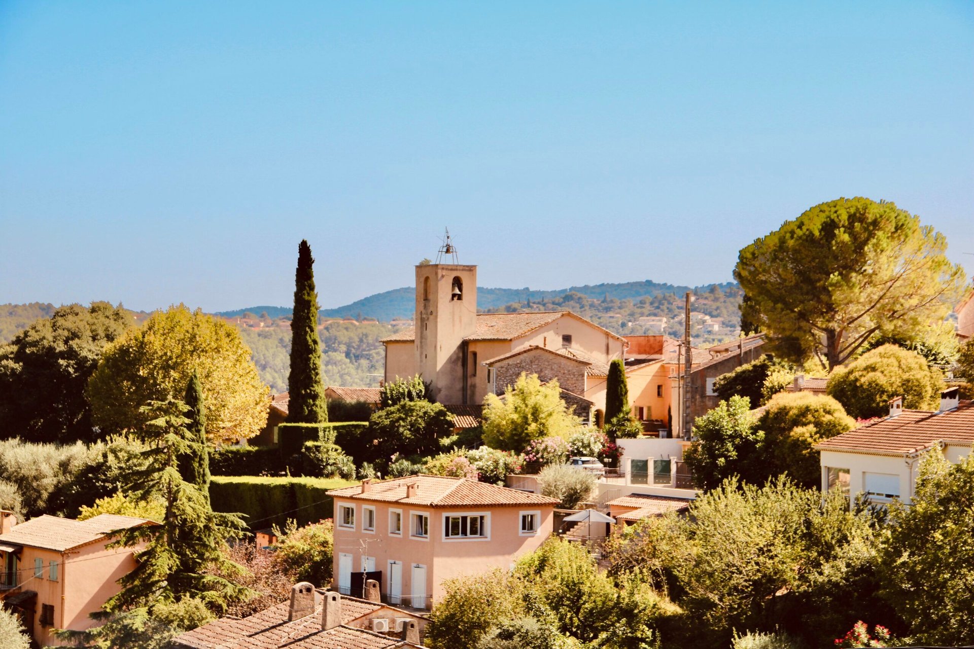 Boats are docked under a bridge in the harbor.
