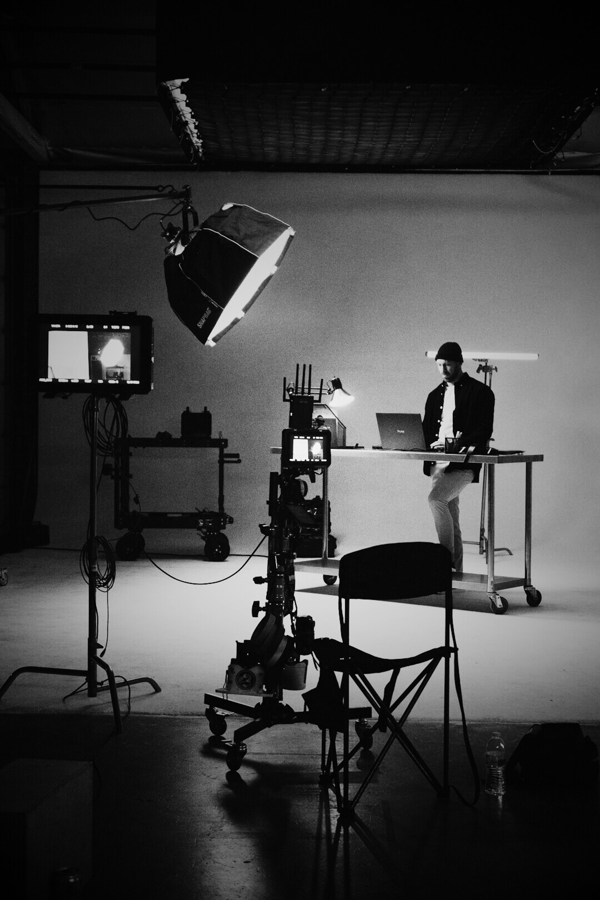 a man sitting at a desk in front of a laptop computer