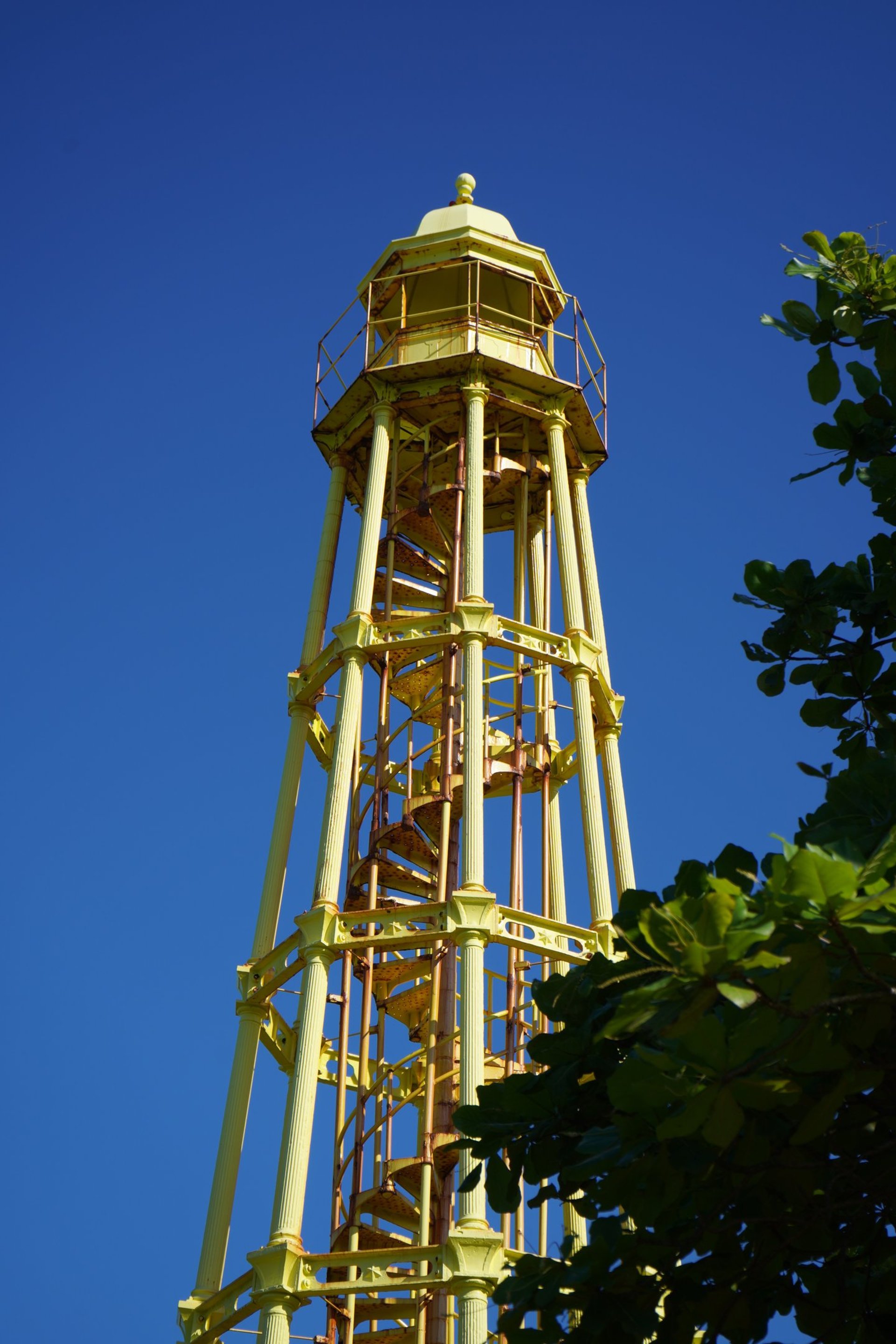 woman wearing yellow long-sleeved dress under white clouds and blue sky during daytime
