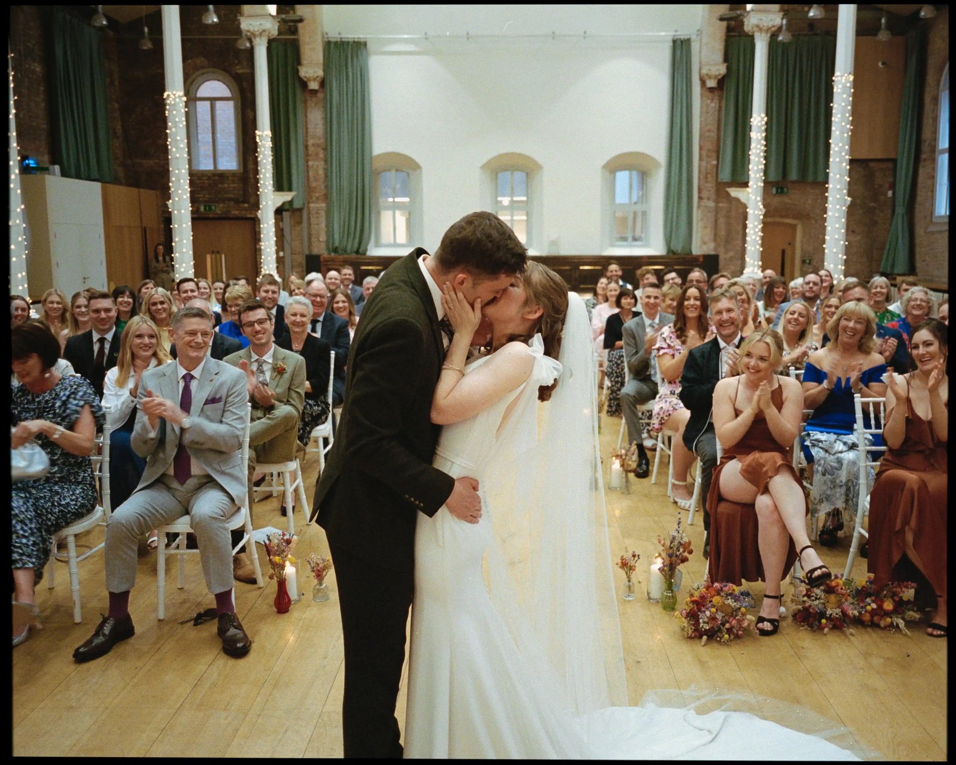 Couple Kissing At Their Wedding Ceremony By David Allbutt