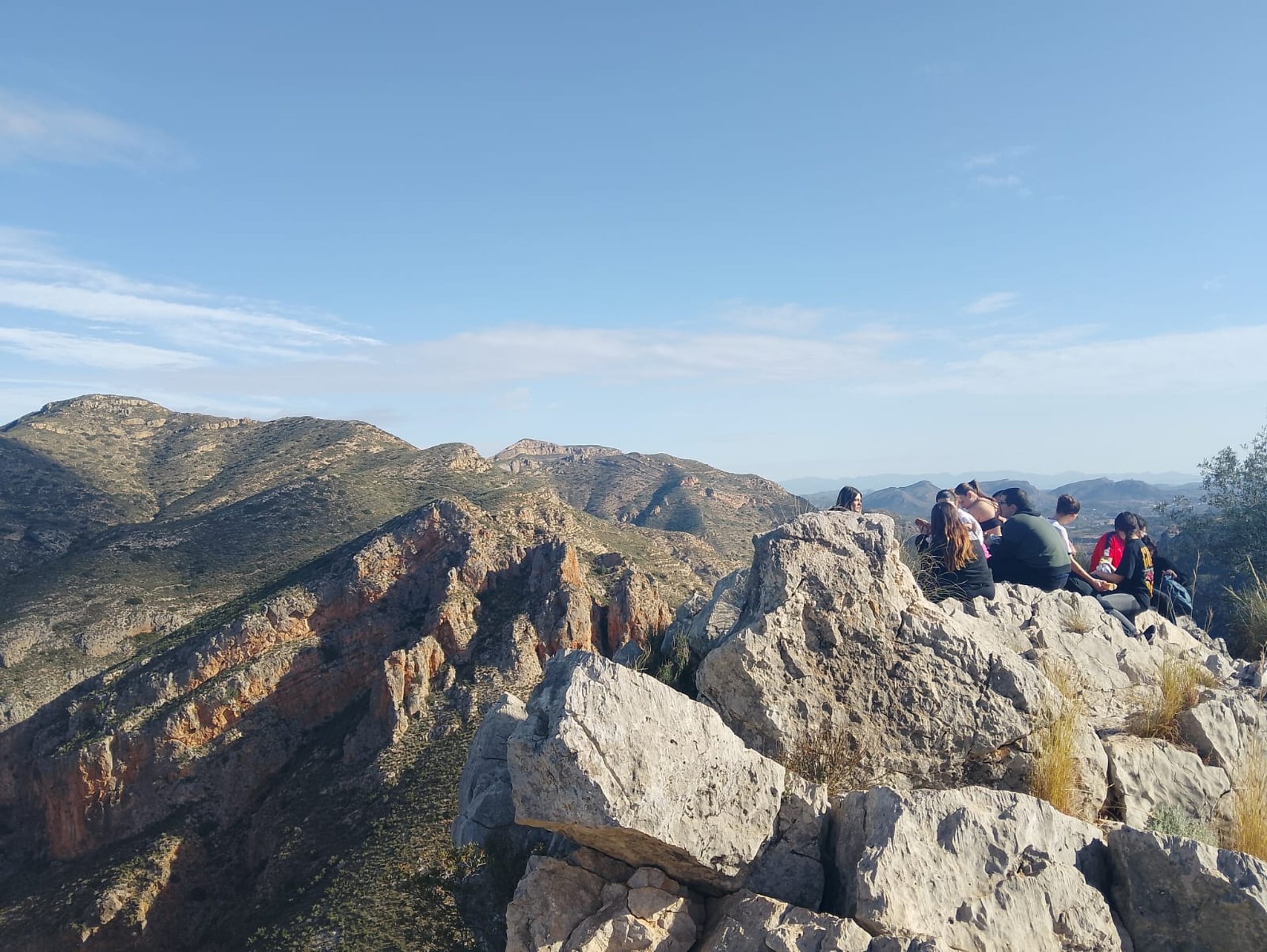 woman wearing yellow long-sleeved dress under white clouds and blue sky during daytime