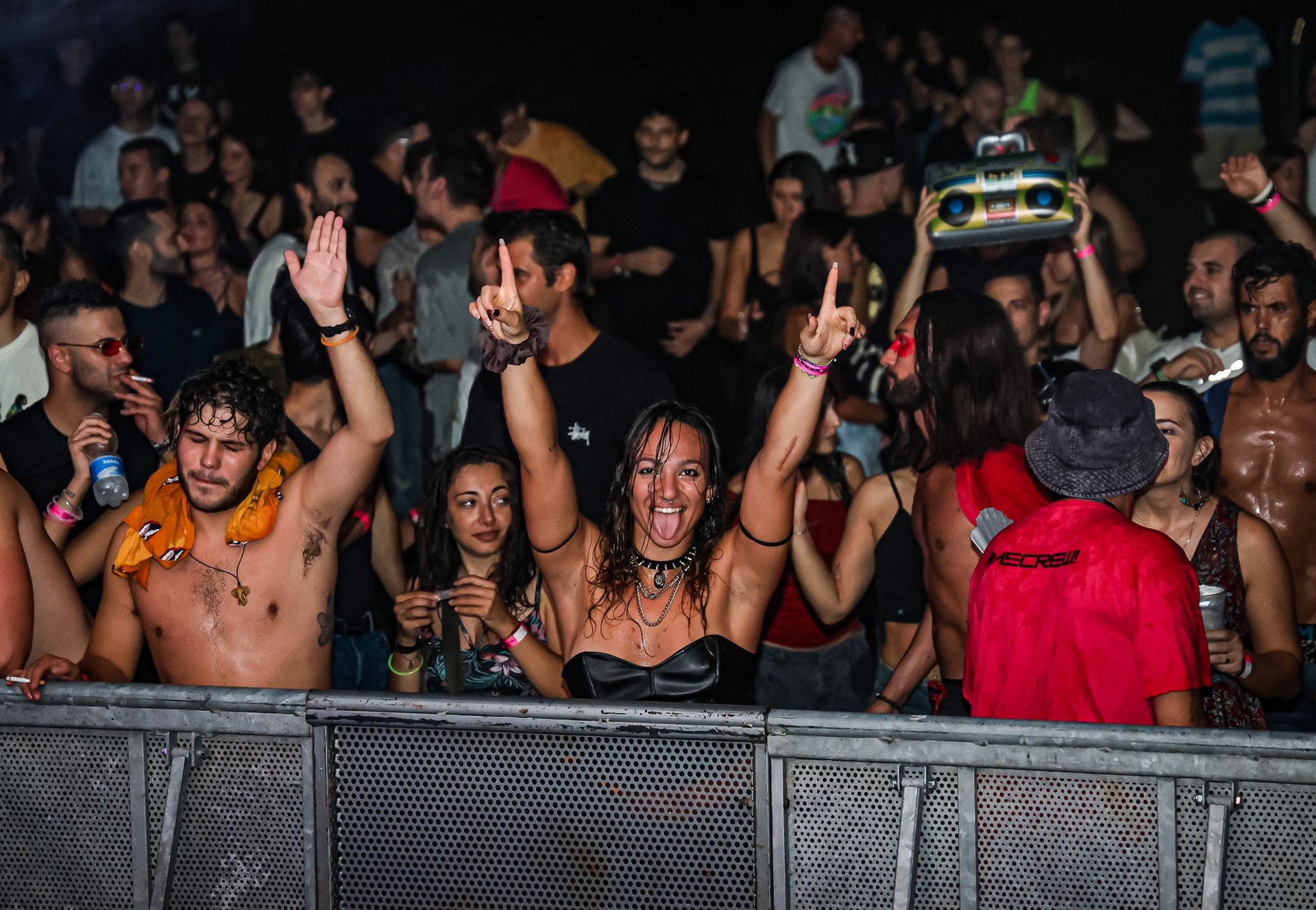 a crowd of people watching a concert on a big screen