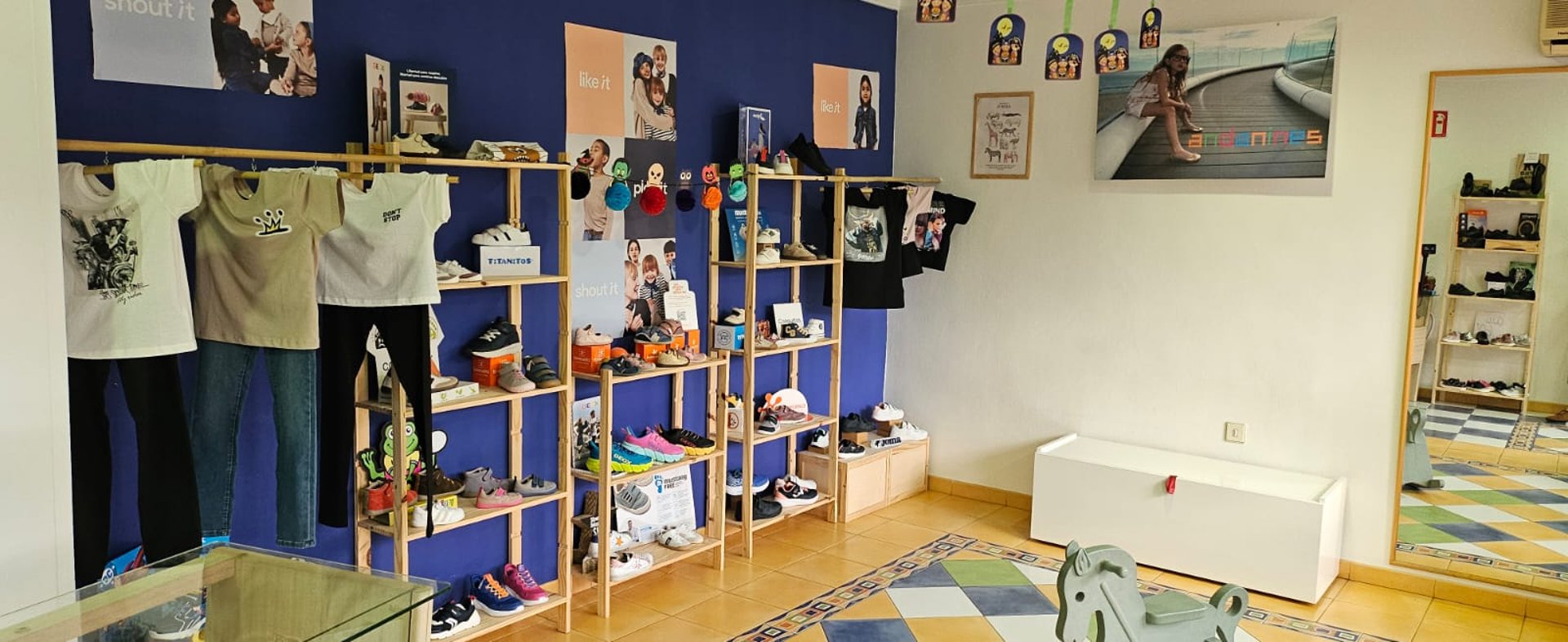 person in blue skirt and white sneakers standing on green grass field during daytime