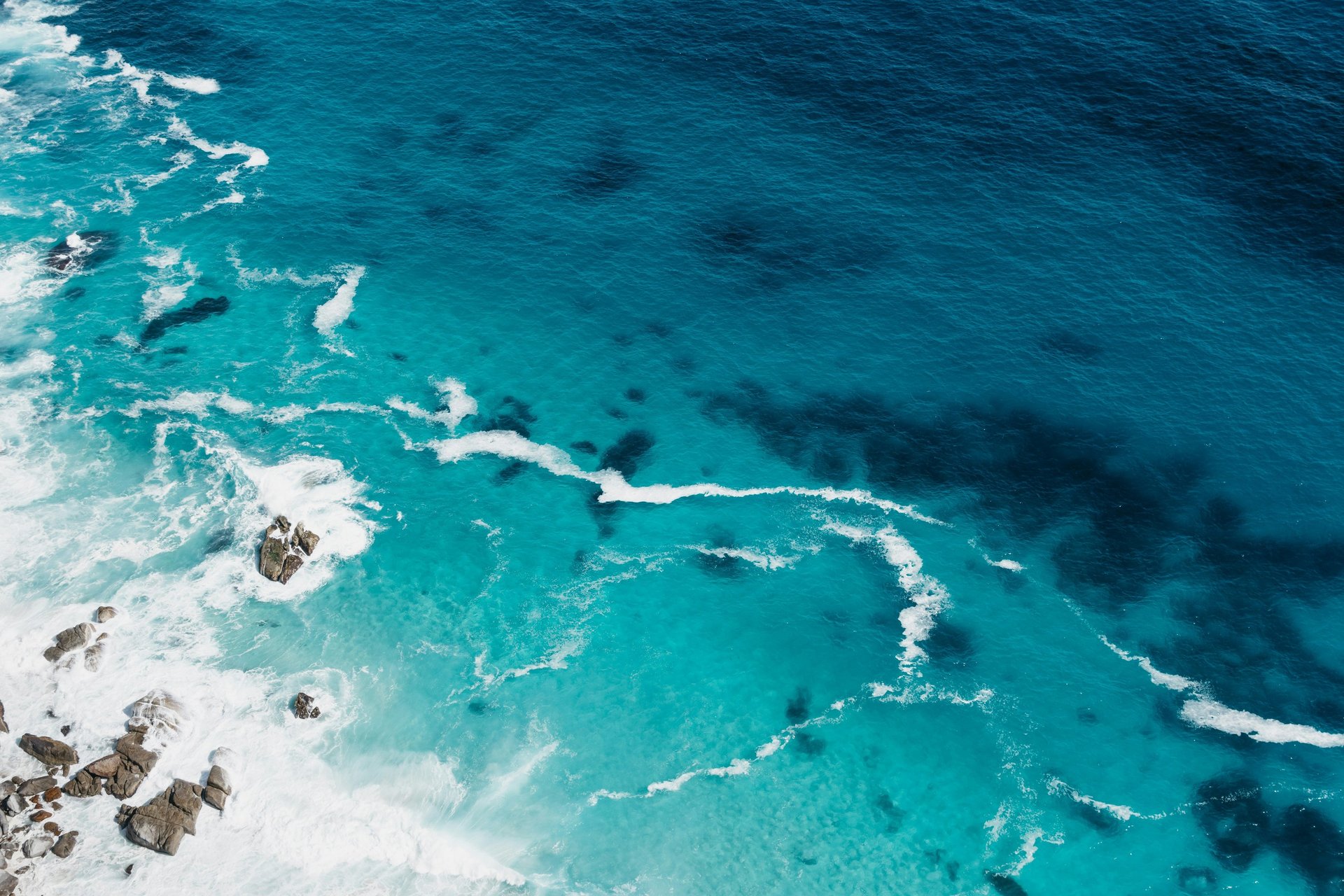 aerial view of two blue boats