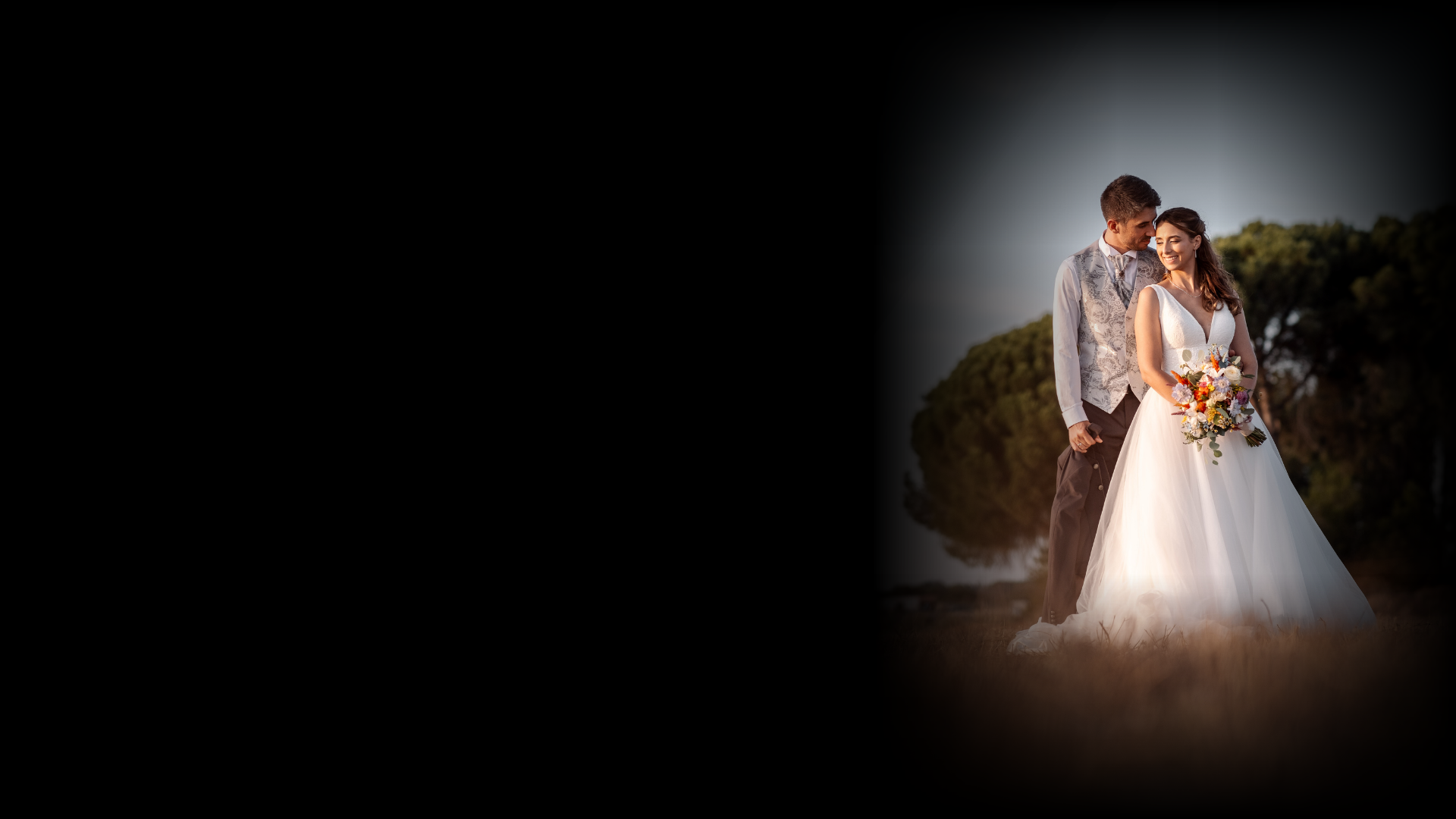 a newly married couple walking through a field