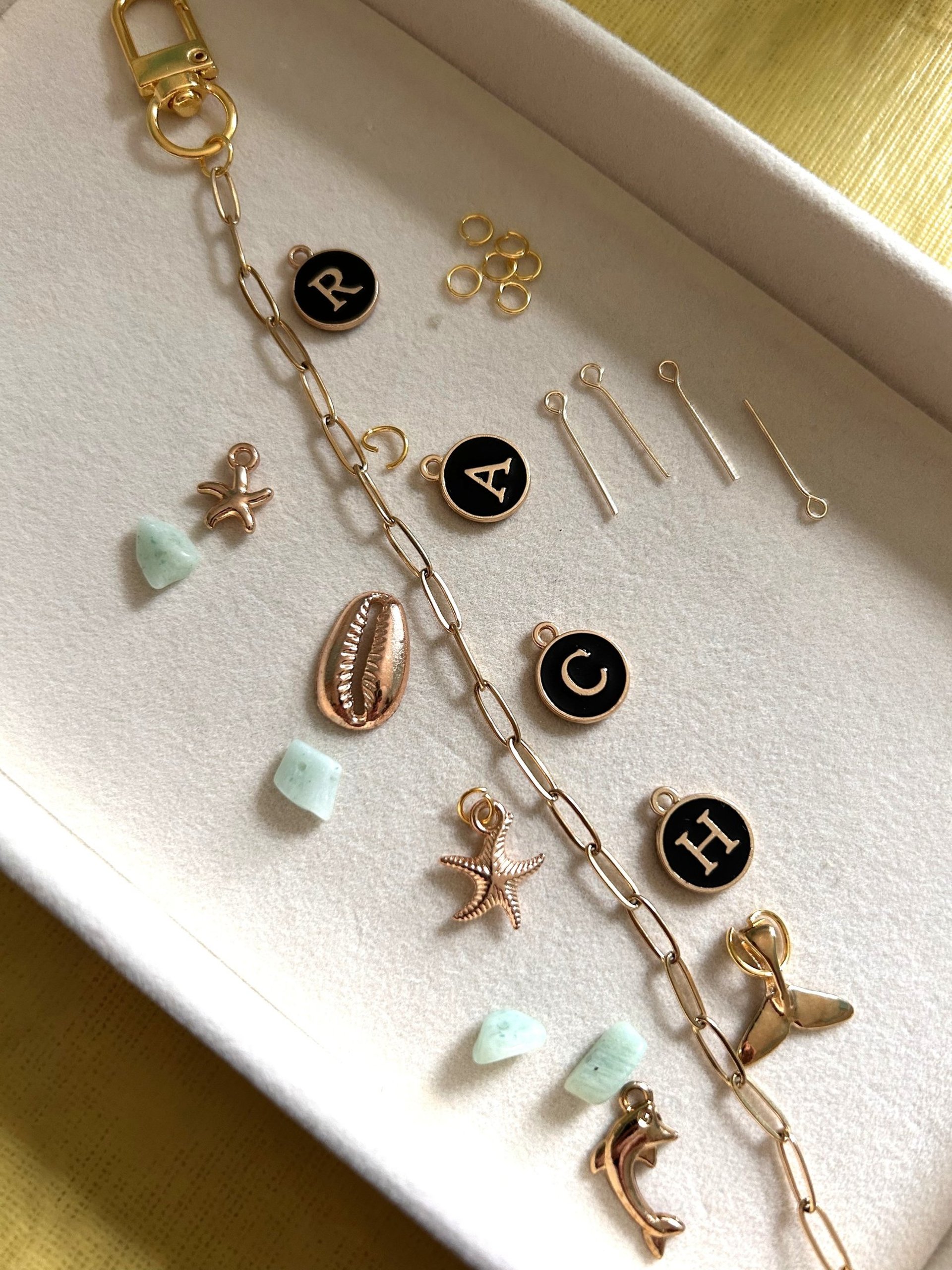 A pair of gold earrings hanging from a string