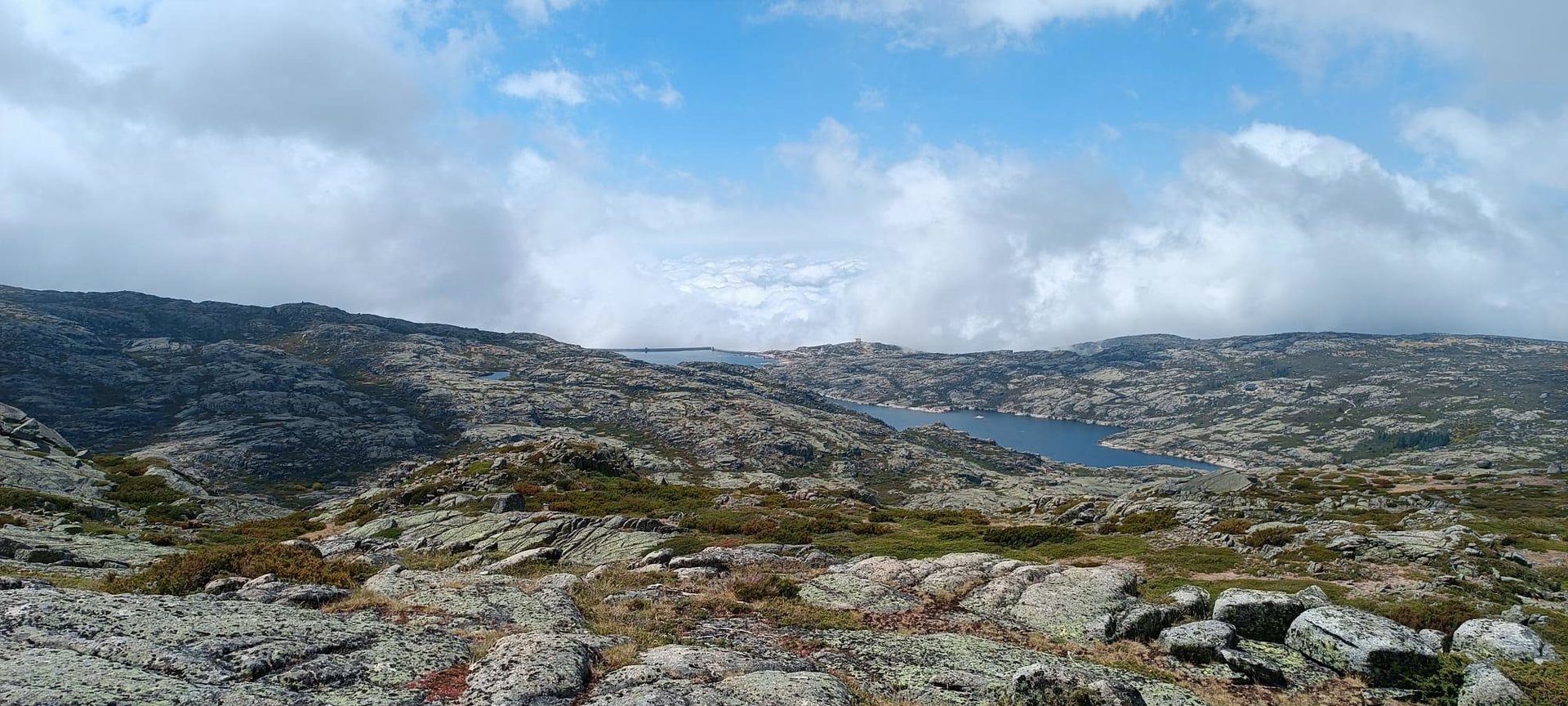 brown rock formation on body of water during daytime