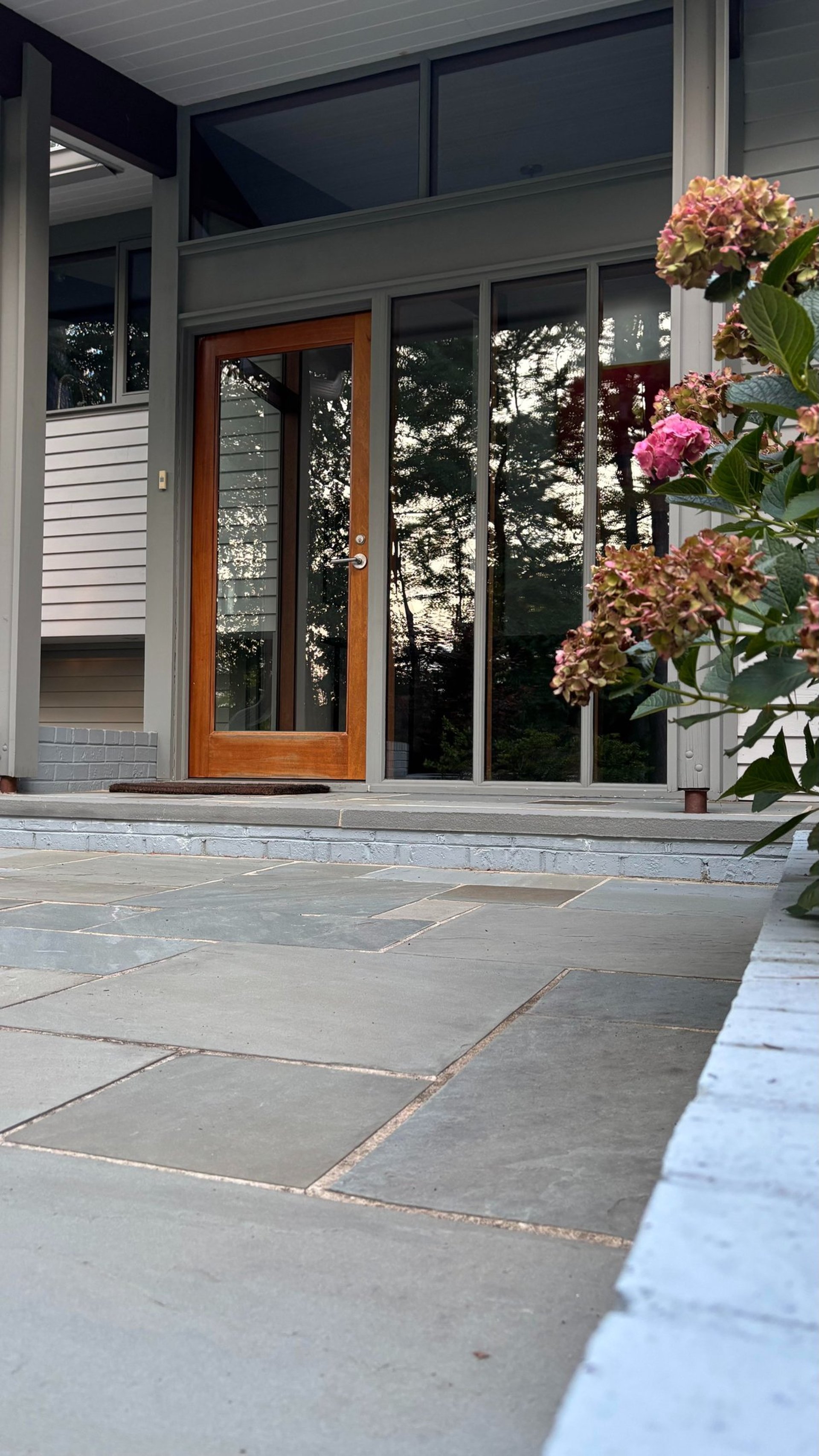 a white house with a tree in front of it