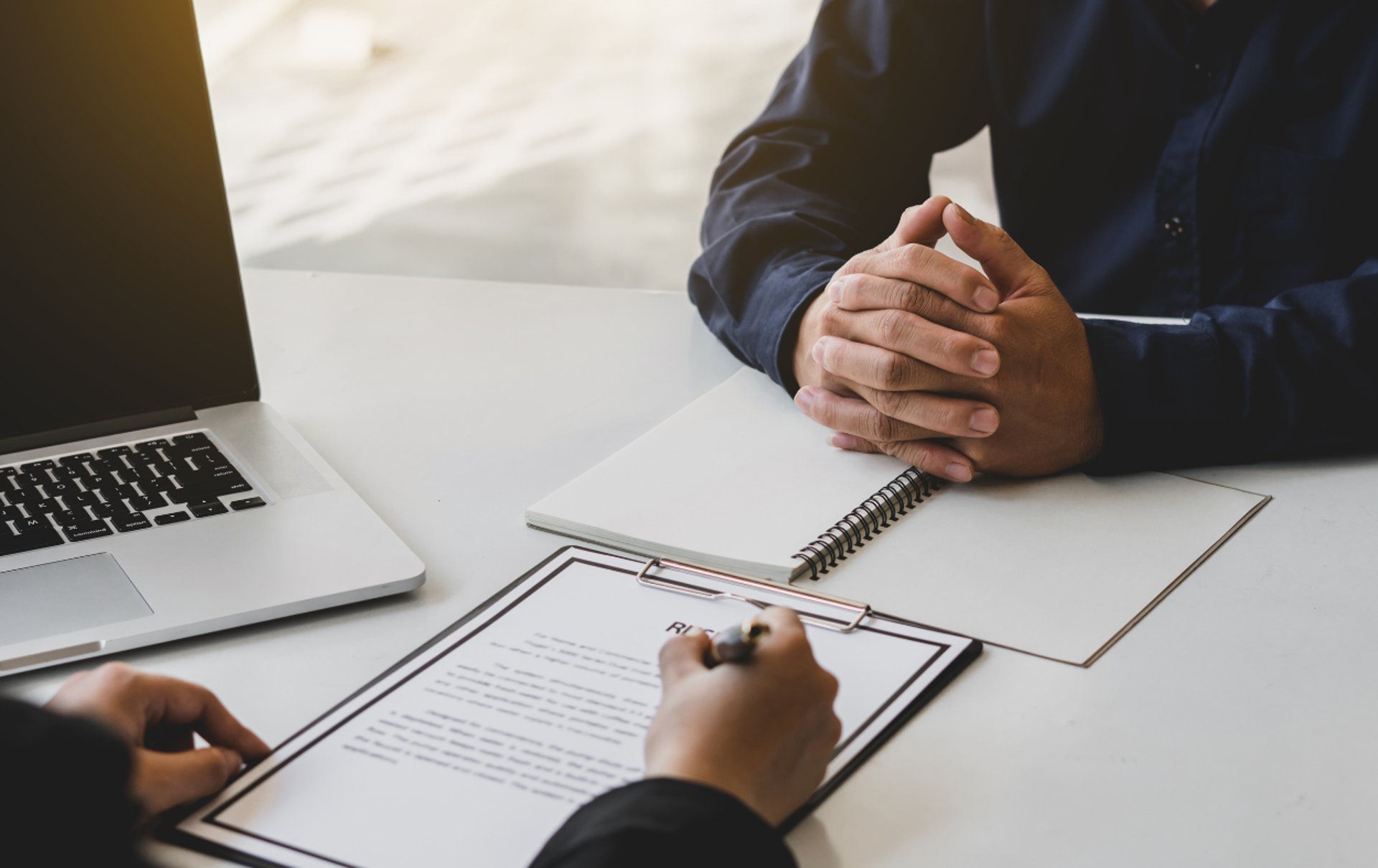 an abstract photo of a curved building with a blue sky in the background