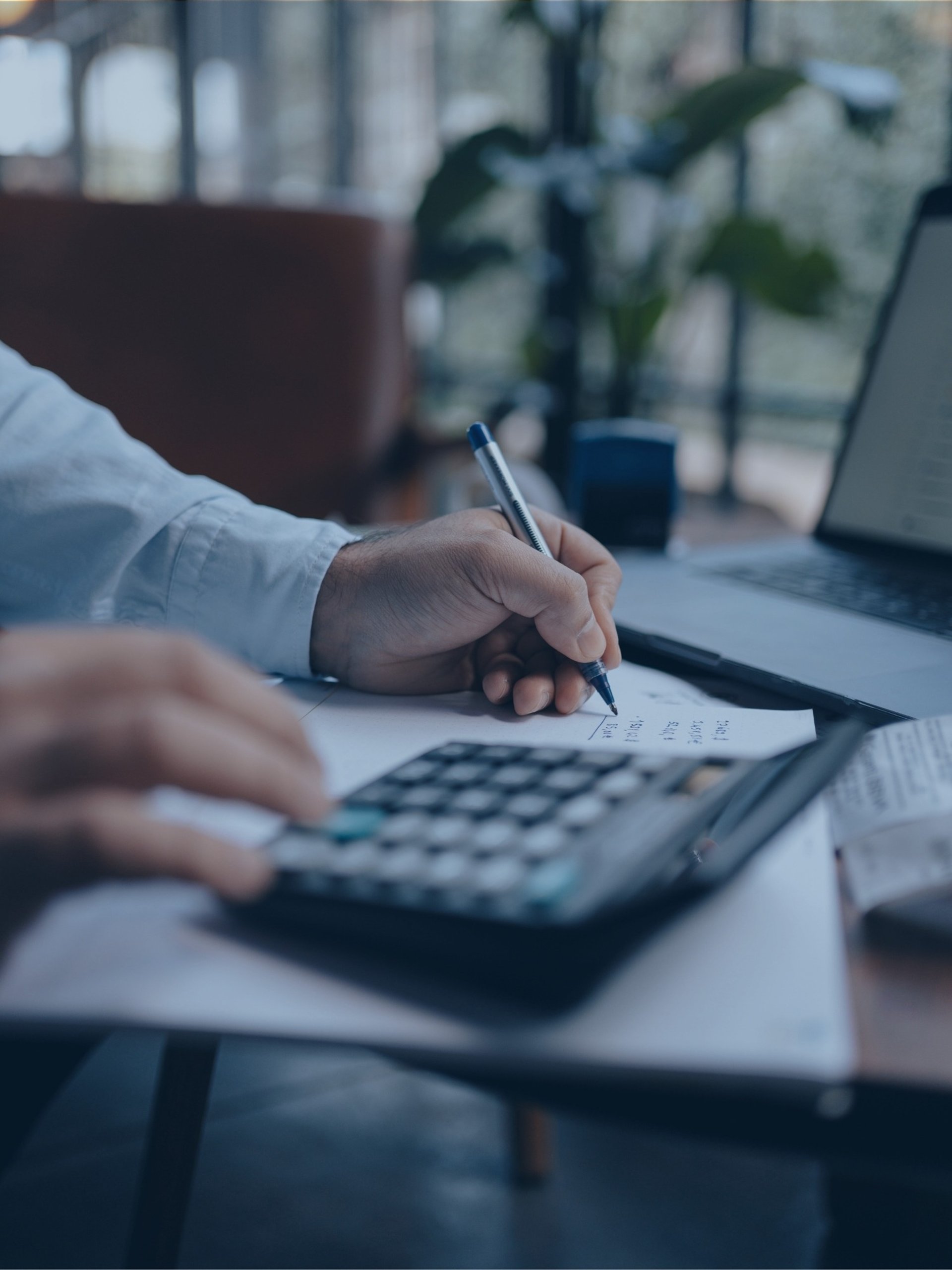 a calculator sitting on top of a pile of papers