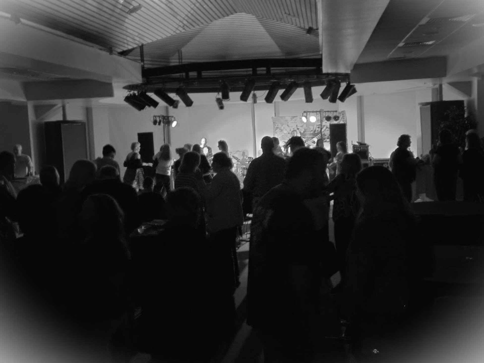grayscale photo of band performing on stage