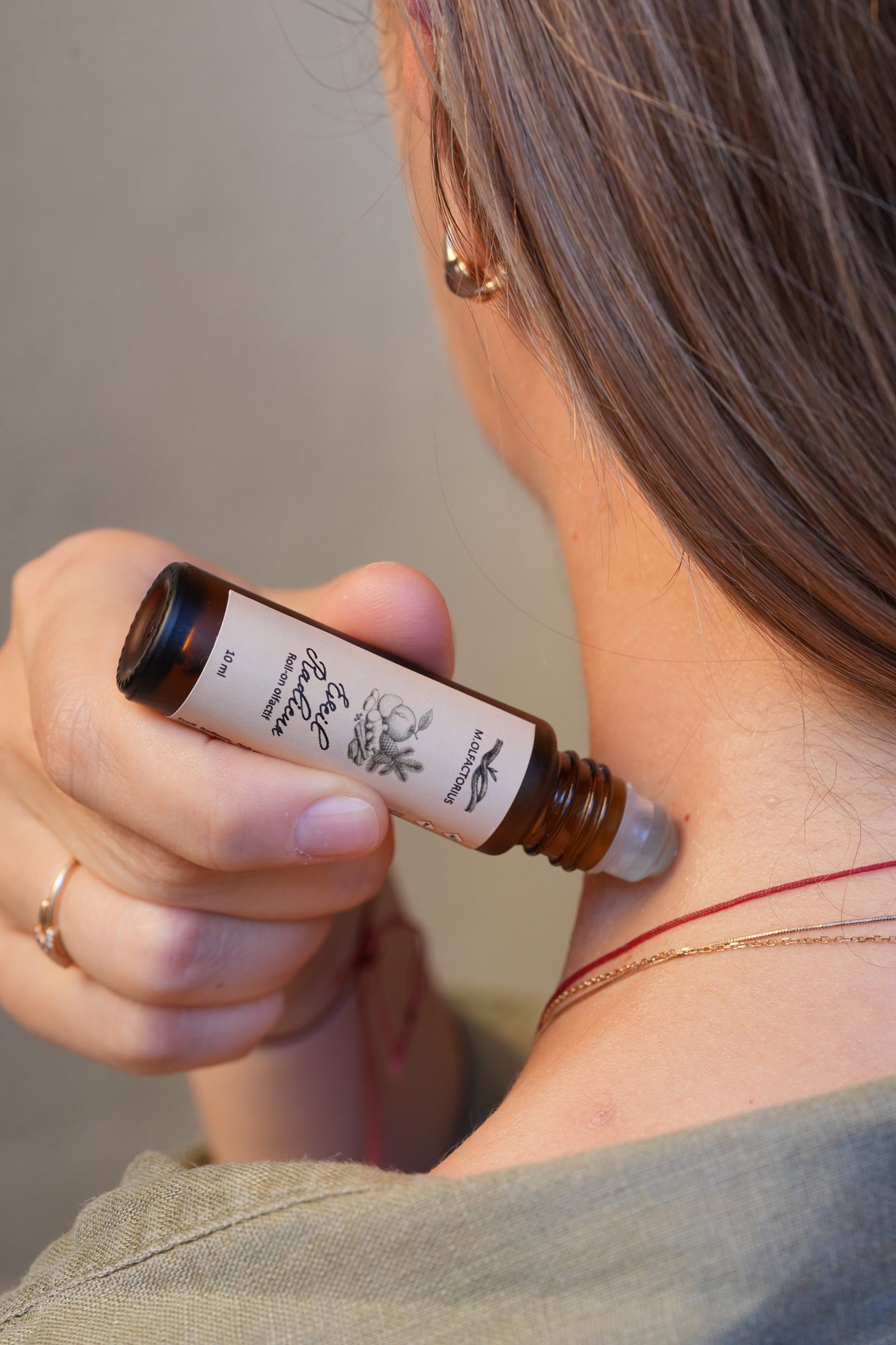 Moisturizing shampoo bottle on a neutral background.