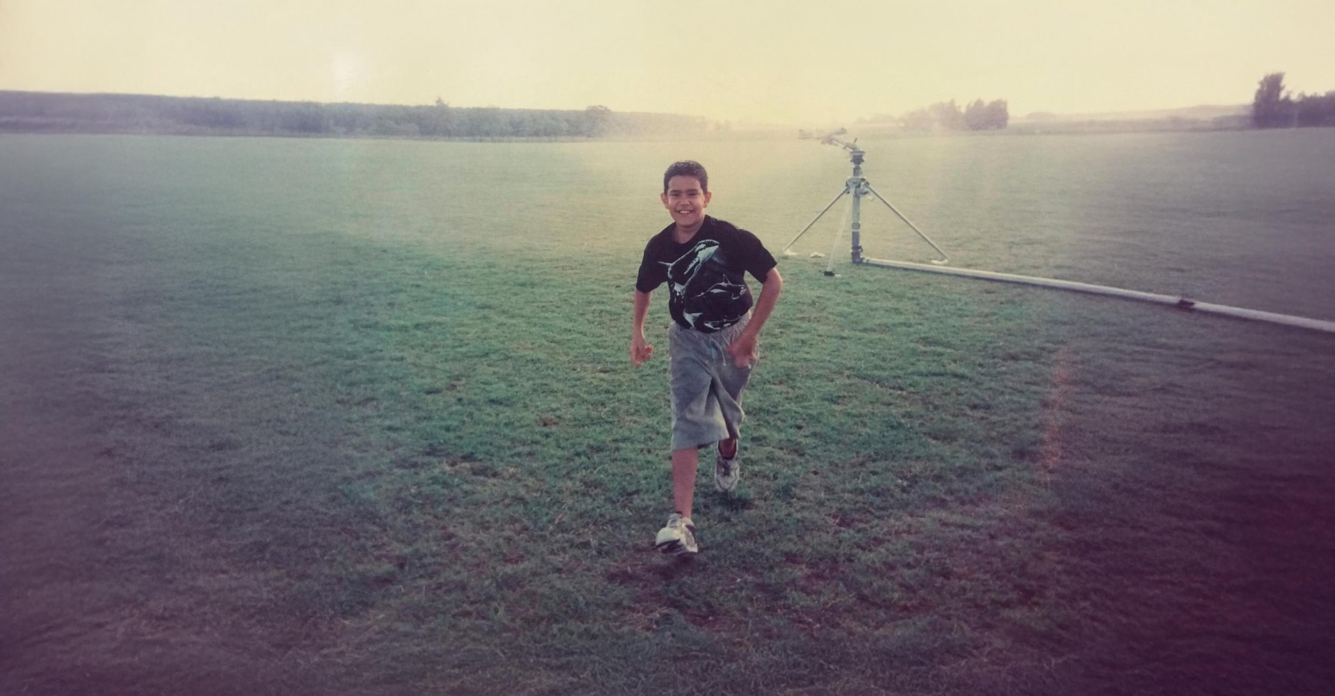 a black and white photo of a man holding a pole