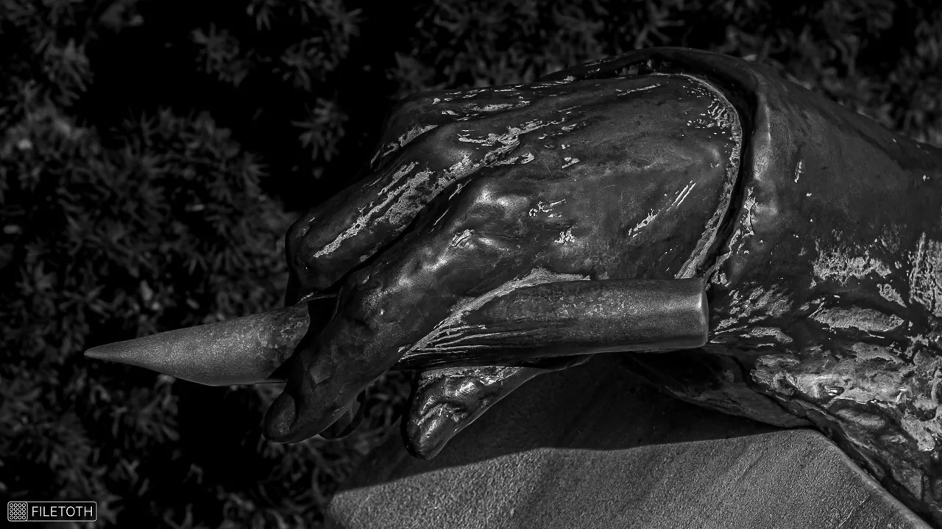 Anonymous’s hand holding a quill pen gestiure of rememberance.