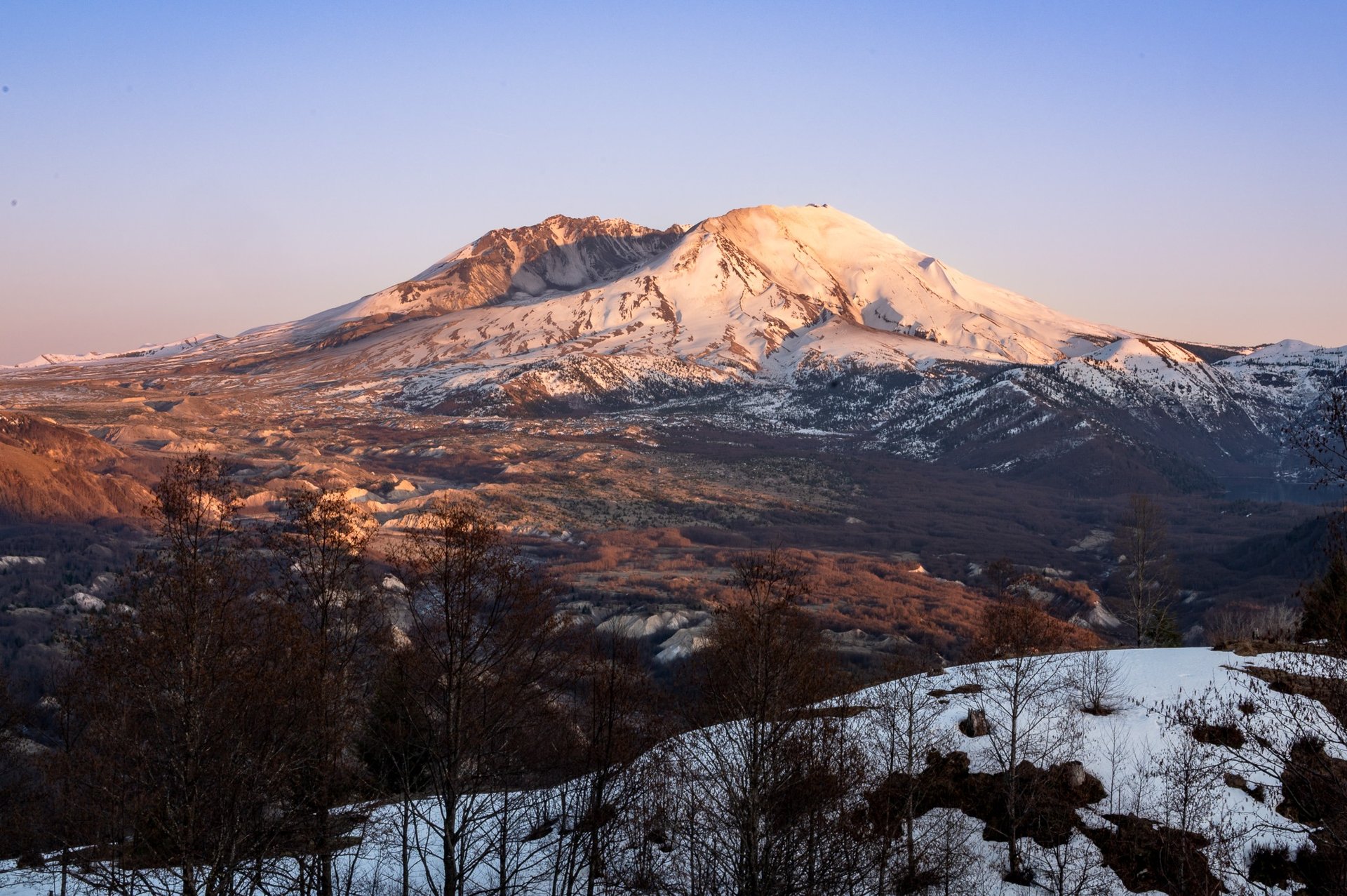 an abstract photo of a curved building with a blue sky in the background