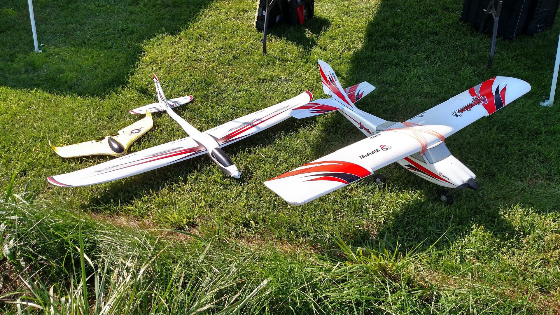 yellow, red, and blue bi-plane flying under blue sky