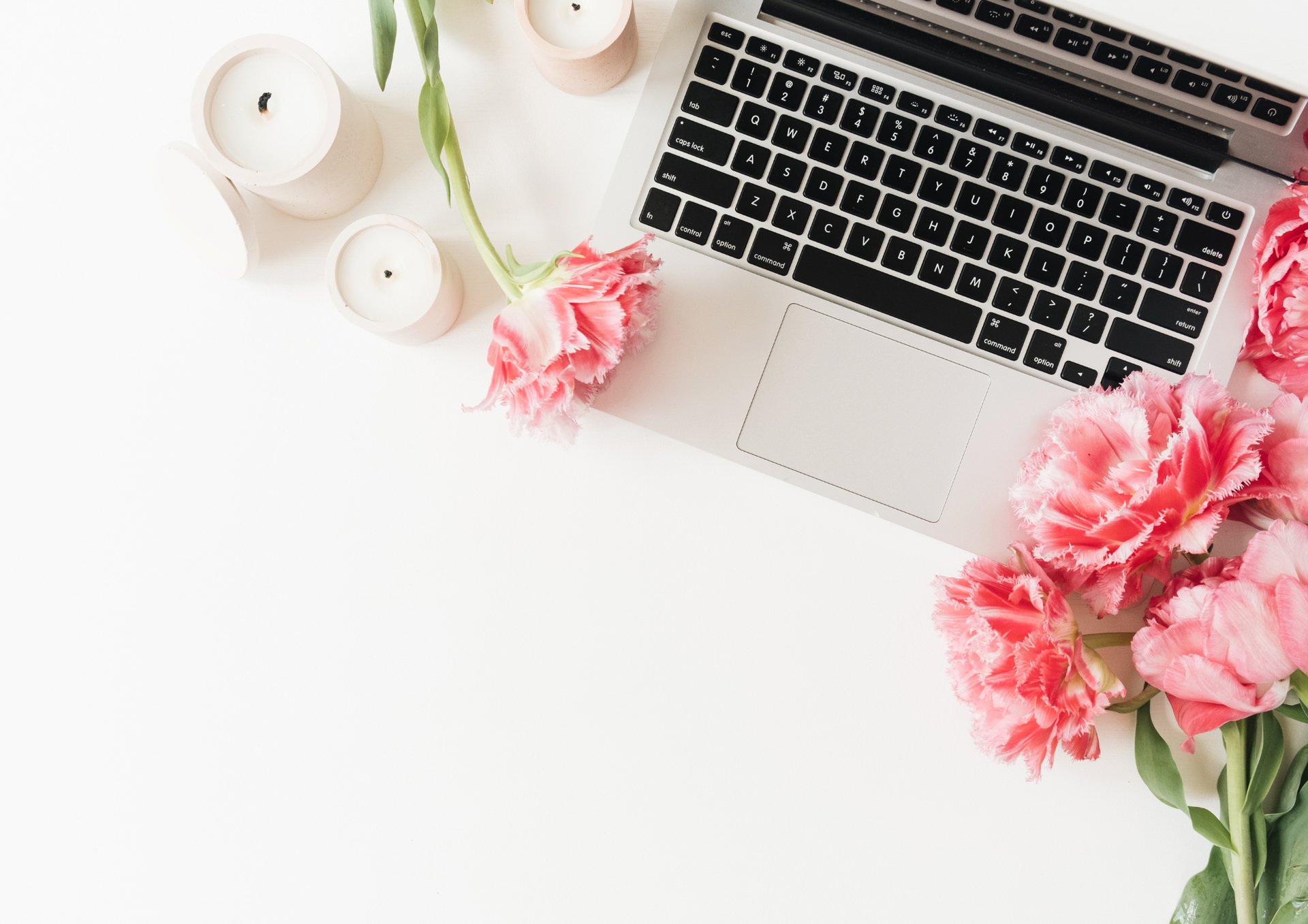 a notebook, glasses, and flowers on a table