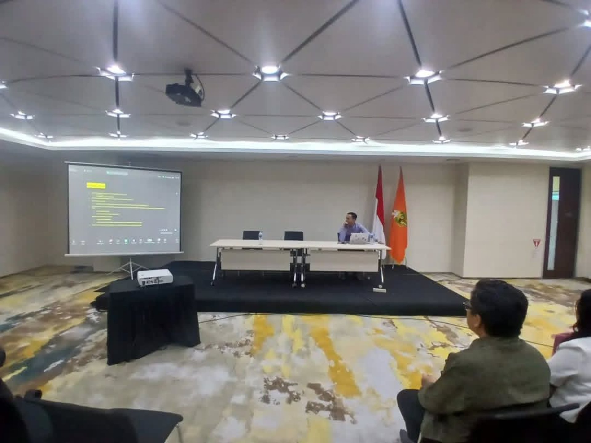 man wearing gray polo shirt beside dry-erase board